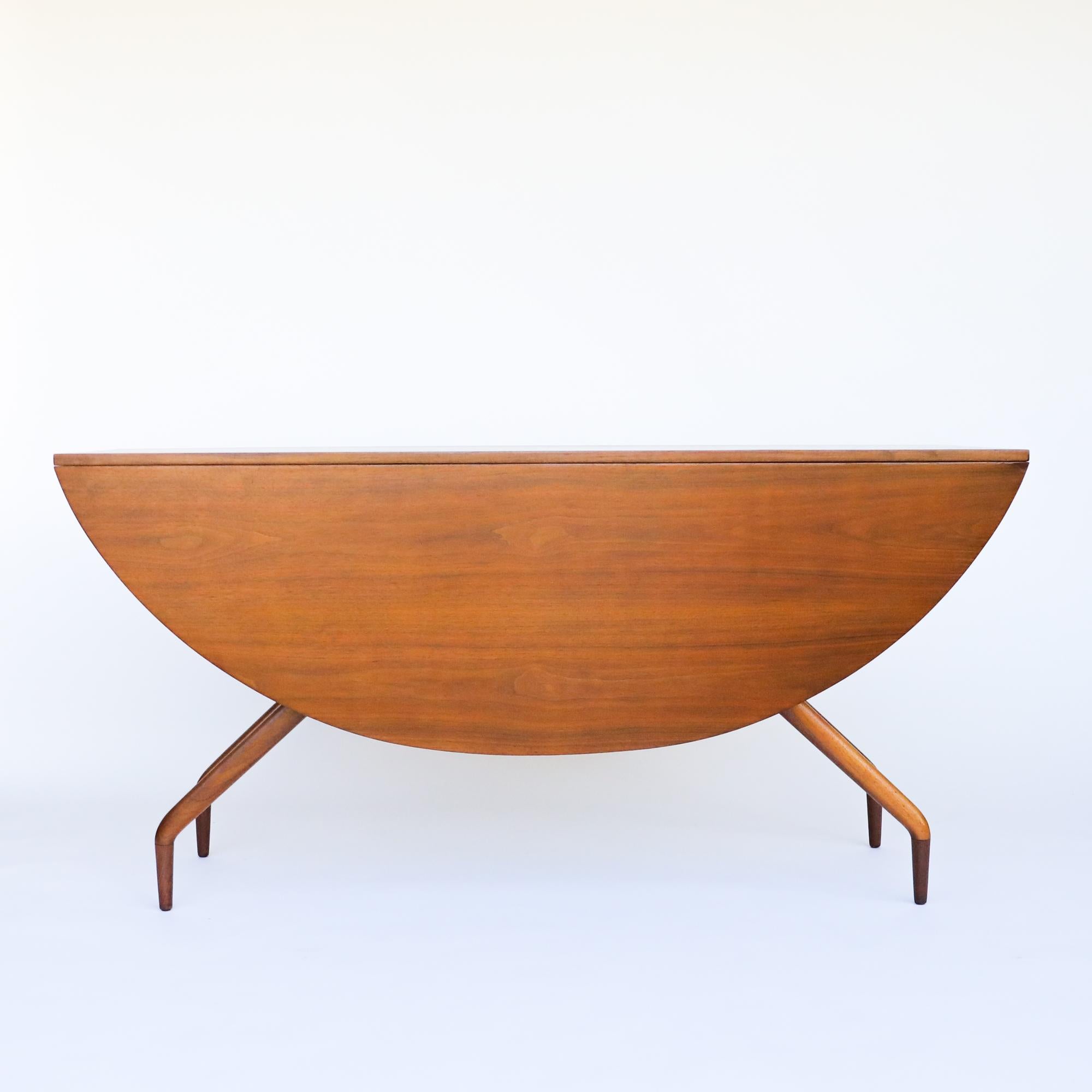 Mid-century modern “Spider” dining table designed by Ed Frank for Glenn of California, circa 1950s. It is often attributed to Greta Grossman as it has  sleek lines and slender proportions. The table is made from walnut and the grain is gorgeous. The