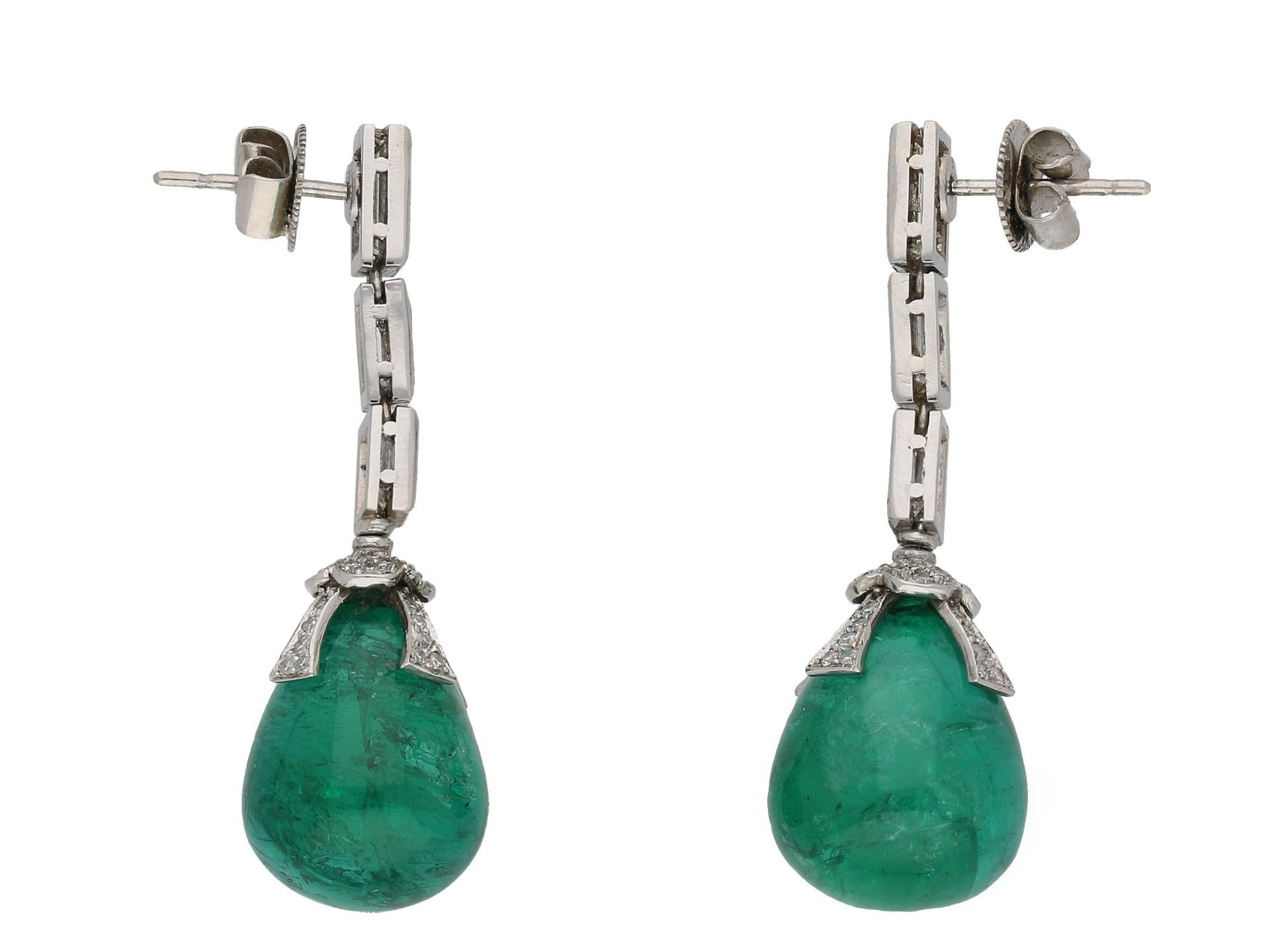 Drop emerald and diamond earrings, circa 1970. A pair of platinum earrings each composed of  drop shaped emerald, the two with an approximate total weight of 36.00 carats, suspended from a four pronged setting surmounted with a four petaled florette