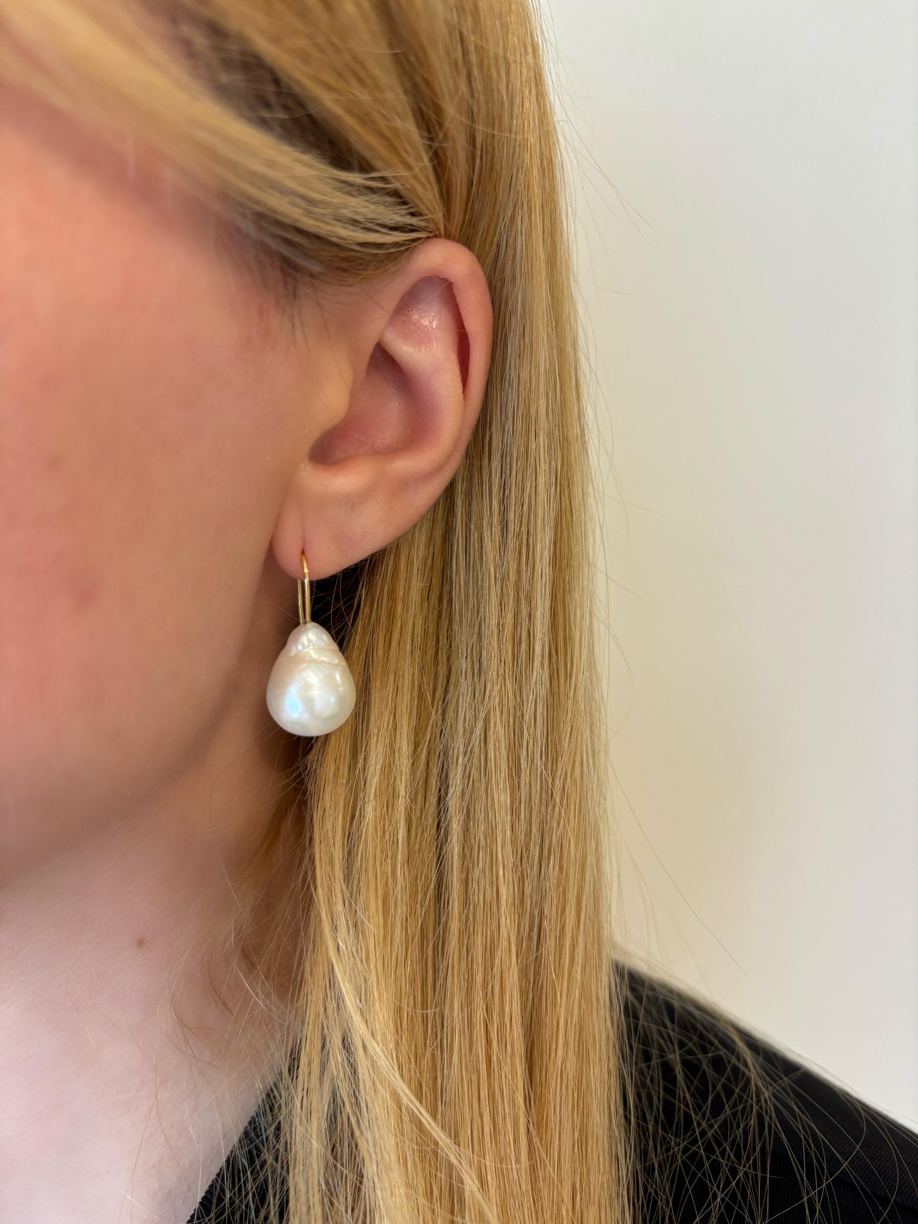 Our Baroque Drop Pearl Earrings are a best seller in our collection. This pair of earrings features baroque, drop shape pearls and a slim 18K Yellow Gold hook design that slips on to the ear. They are easy to slip on and comfortable to wear all day