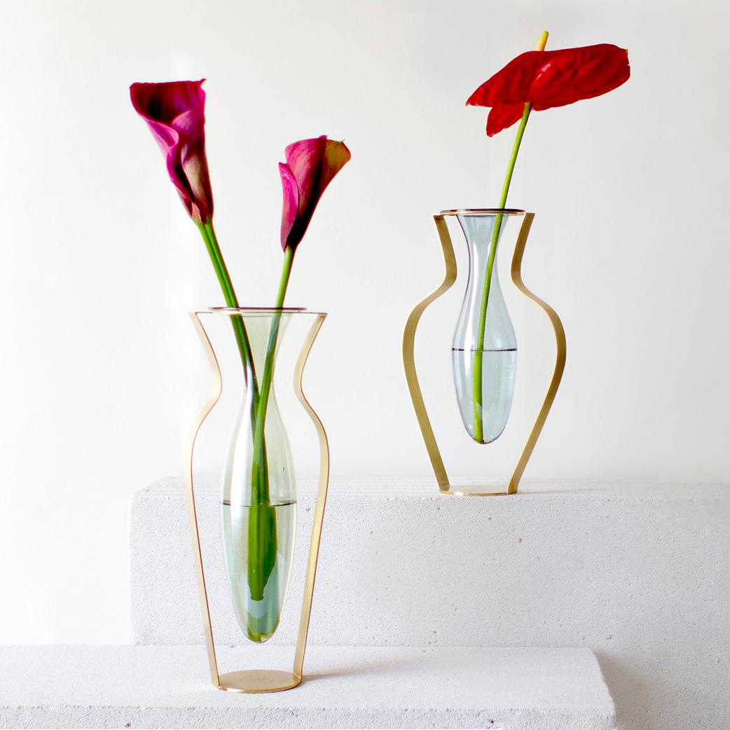 A set of 2 handblown glass and titanium gold plated stainless steel vases; tall green and wide blue colored. 

Care Instructions:  Wash in hand for best use of the glass parts and wipe the metal frame with a wet/dry cloth when needed.

Droplet