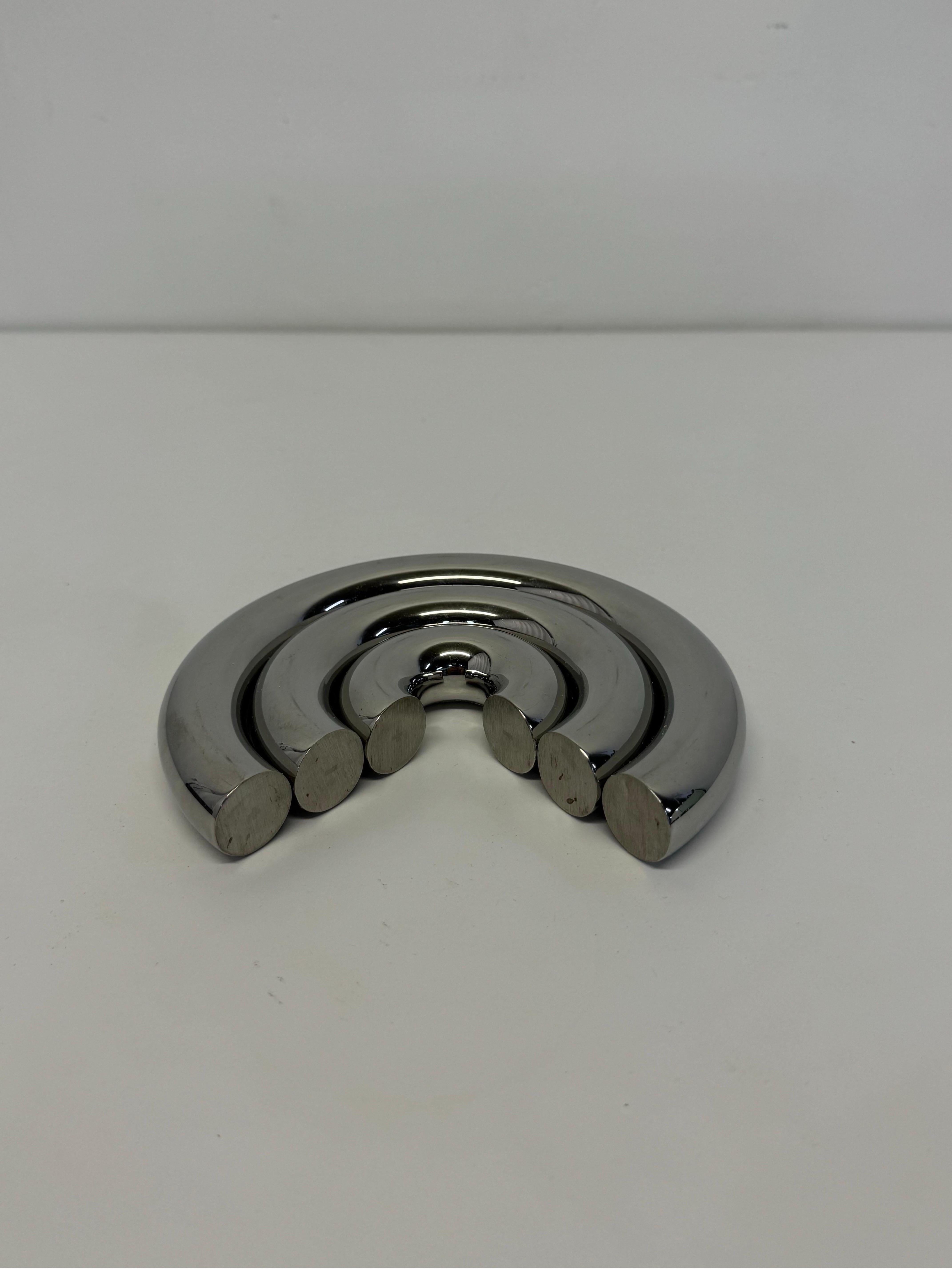 Stainless steel trivet with adjustable elements by Dror Benshetrit for Alessi. 

Dror's new Try It trivet for Alessi is a toy in its own right: The three magnetic metal circles can be nested, separated, rearranged into curvy patterns, or even worn