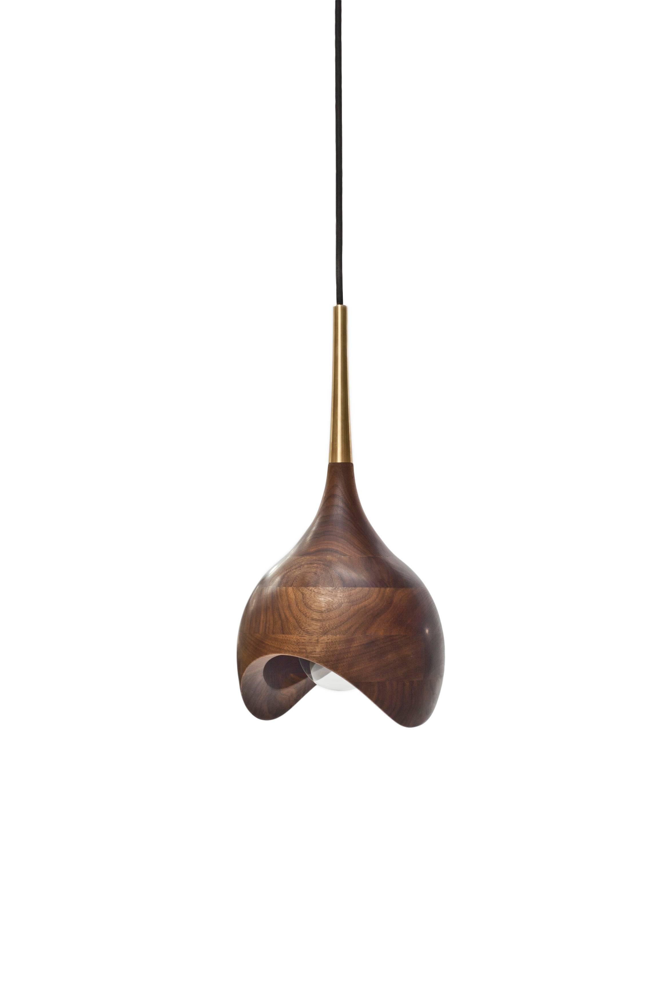 Words from the designer: Dråpe (Norwegian for drop) is based on the shape of a water drop. The open end means the design completely changes when viewed from different angles. I just love the organic look. Also, the brass top (which I had some great