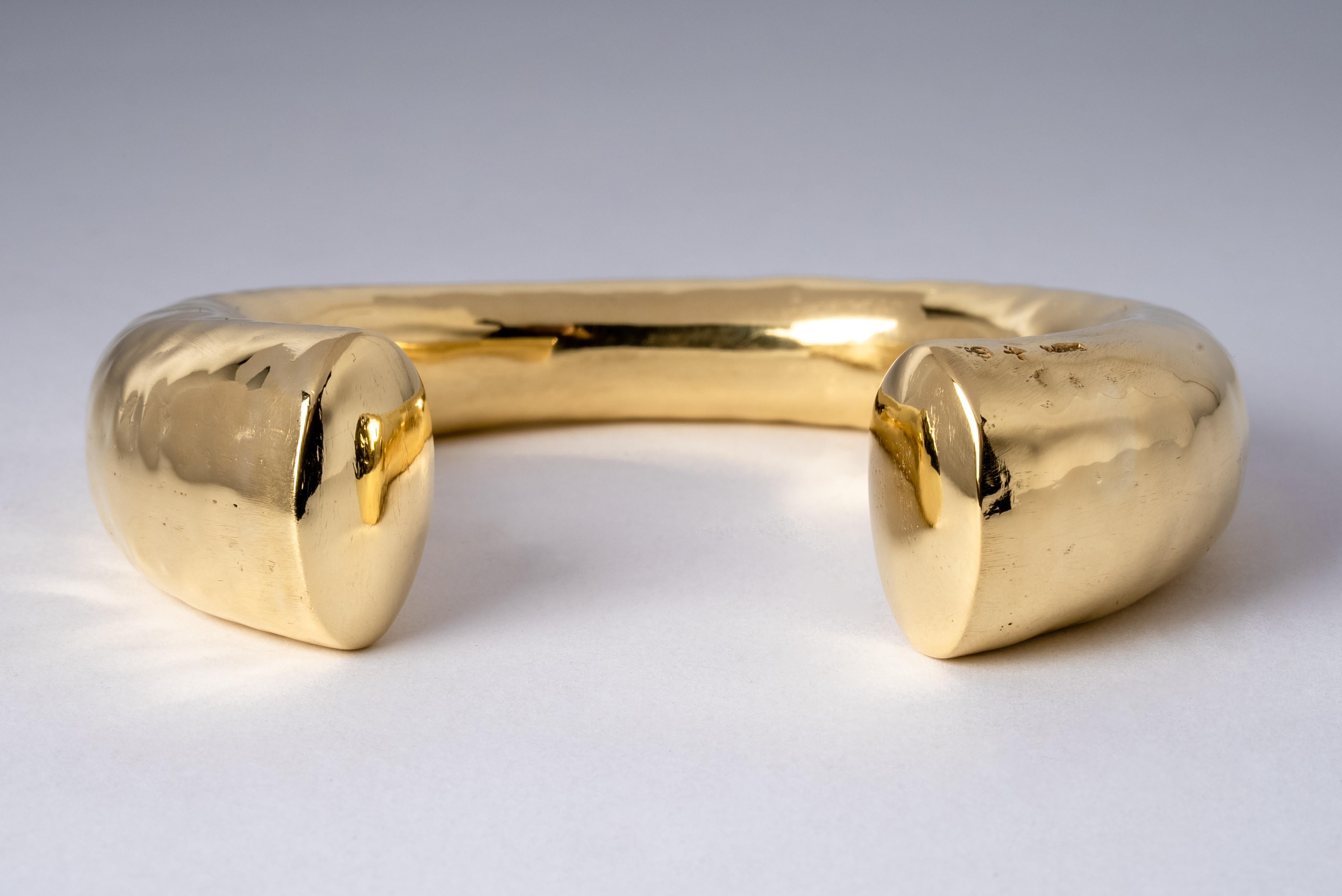 Bracelet in brass. The color of bright gold from brass substrate, polished and electroplated with 18k gold. This piece is 100% hand fabricated from metal plate; cut into sections and soldered together to make the hollow three dimensional form. If