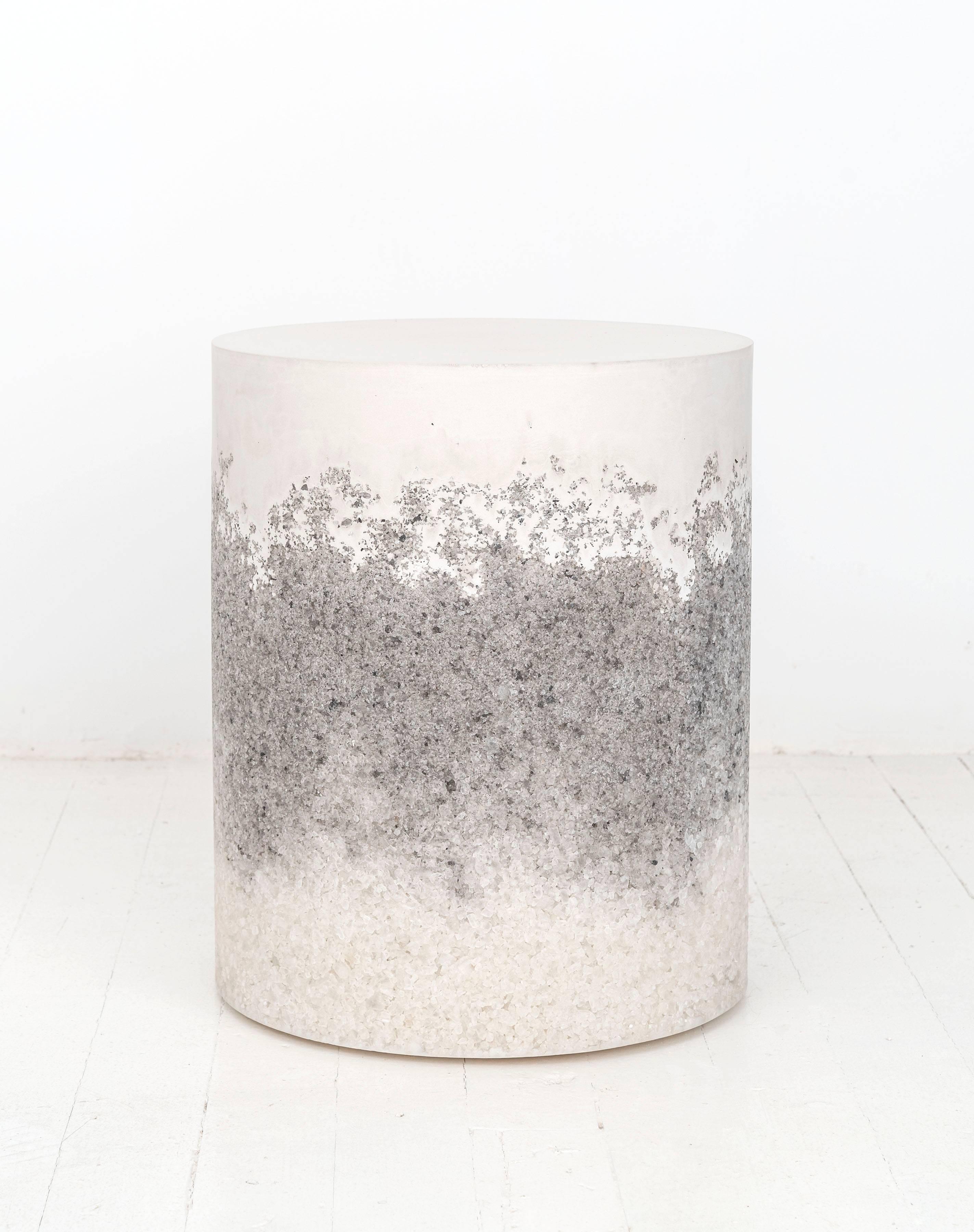 A layering of cement and crushed aggregates, the made-to-order drum consists of a hand-dyed white cement top and a packed white rock salt center and grey rock salt bottom. Poured by hand over the jagged granules, the white cement combines the