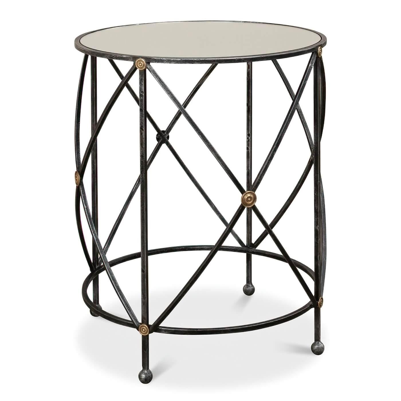 A drum and fife modern side table, the round accent table with a mirror glass top and an iron base with brass rosette accents raised on ball feet.

Dimensions: 24