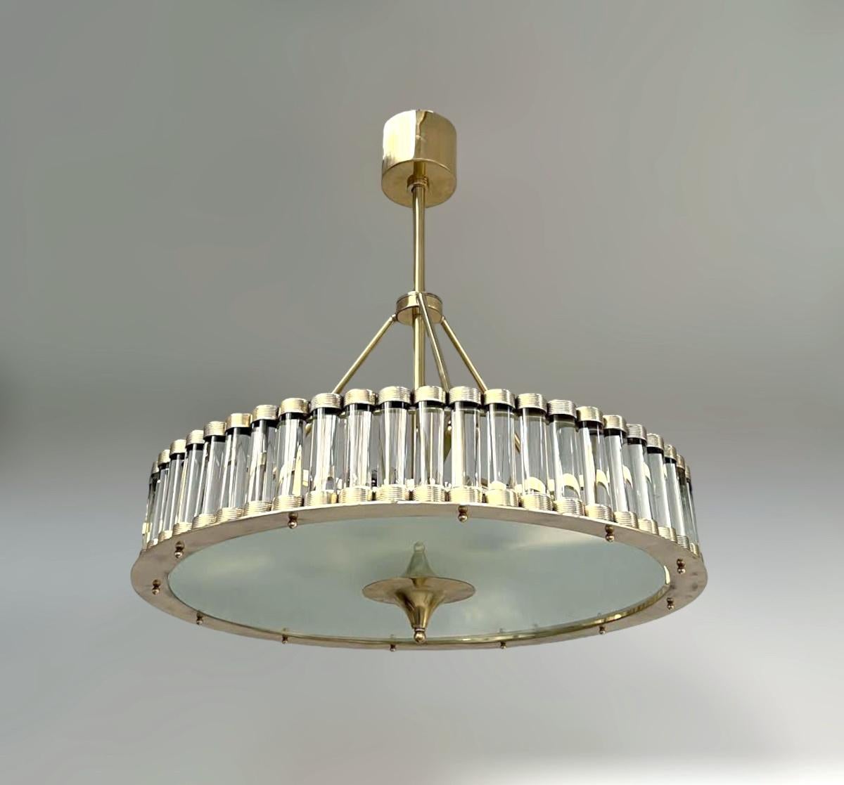 Italian art deco style drum chandelier with clear Murano glass rods mounted on solid brass frame in unlacquered natural brass finish / Made in Italy
6 lights / E26 or E27 type / max 60W each
Measures: diameter 27.5 inches, height 30 inches including