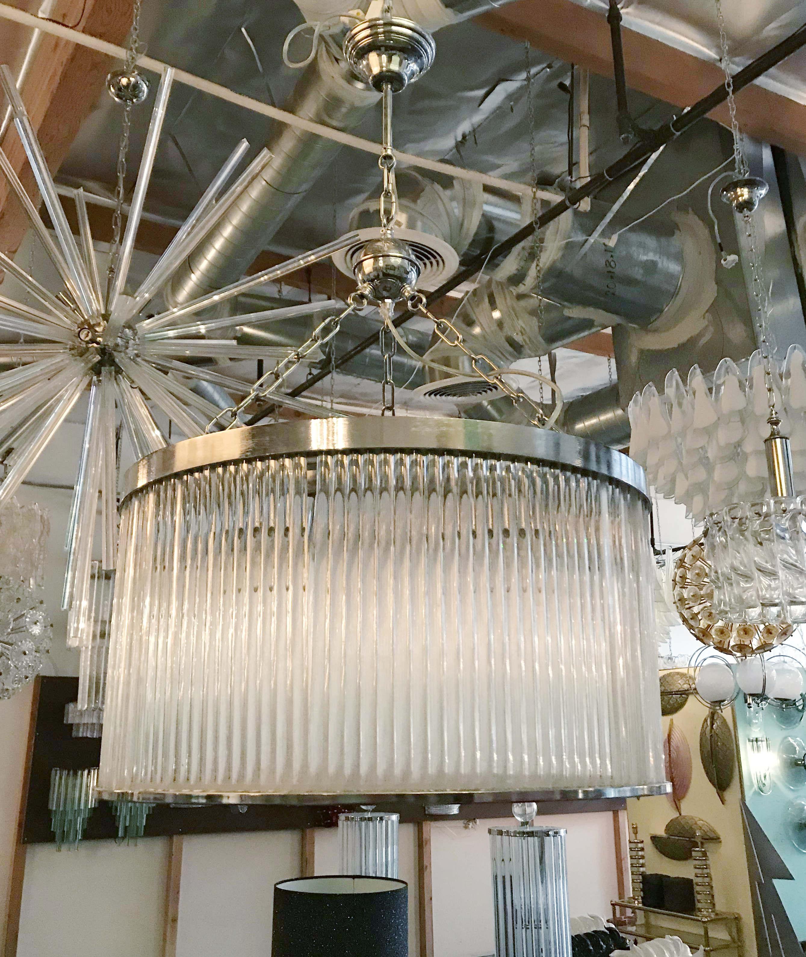 Vintage chandelier with two layers of clear glass rods arranged to form a drum shape with acrylic bottom diffuser, mounted on chrome frame / Made in Italy circa 1980s
6 lights / E26 or E27 type / max 60W each
Measures: Diameter 24 inches / height 14