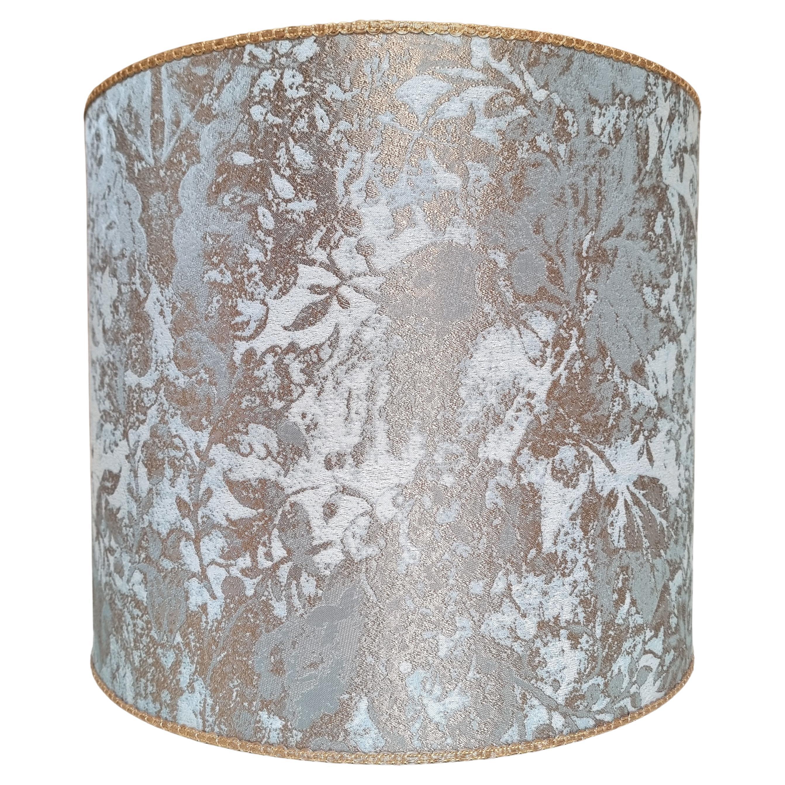 This drum lampshade is handmade using Rubelli jacquard fabric - Mirage pattern - in aqua blue color, finished with gold trim. Suitable for any table lamp.

The Mirage viscose and cotton jacquard is a typical example of the processing of historical