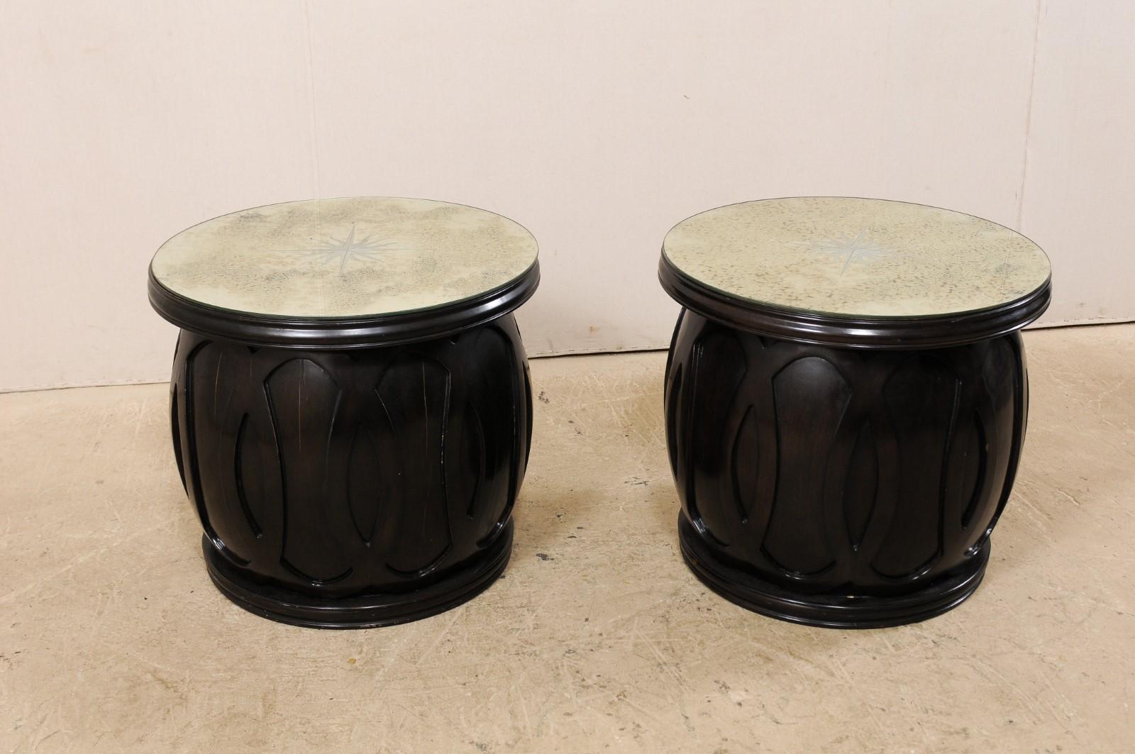 A pair of vintage drum-style side table bases which have been topped with artisan made mirror tops. This pair of side tables feature new artisan made 27.5
