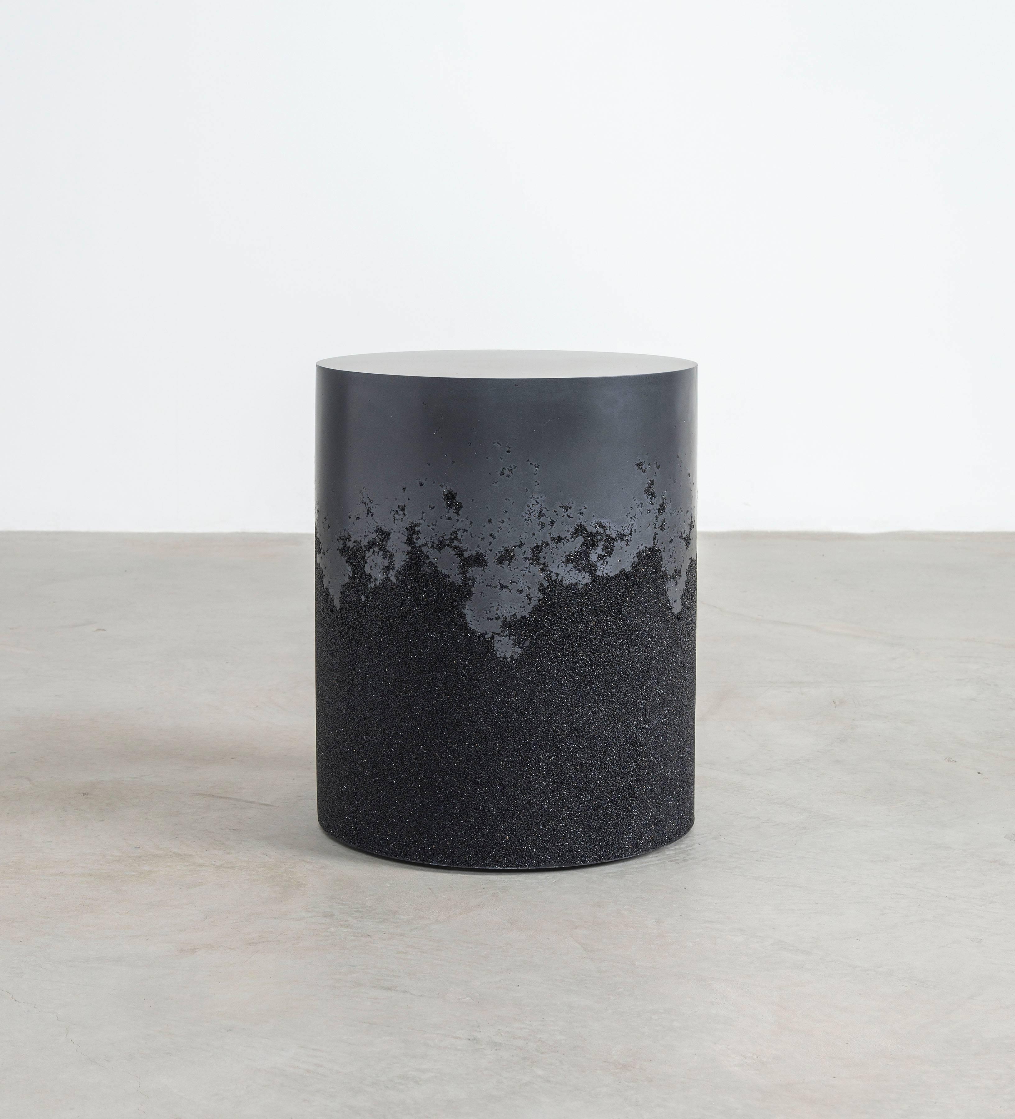 A layering of cement and crushed aggregates, the made-to-order drum consists of an hand-dyed black cement top and a packed black silica bottom. Poured by hand over the jagged minerals, the black cement merges the materials to create a unique organic