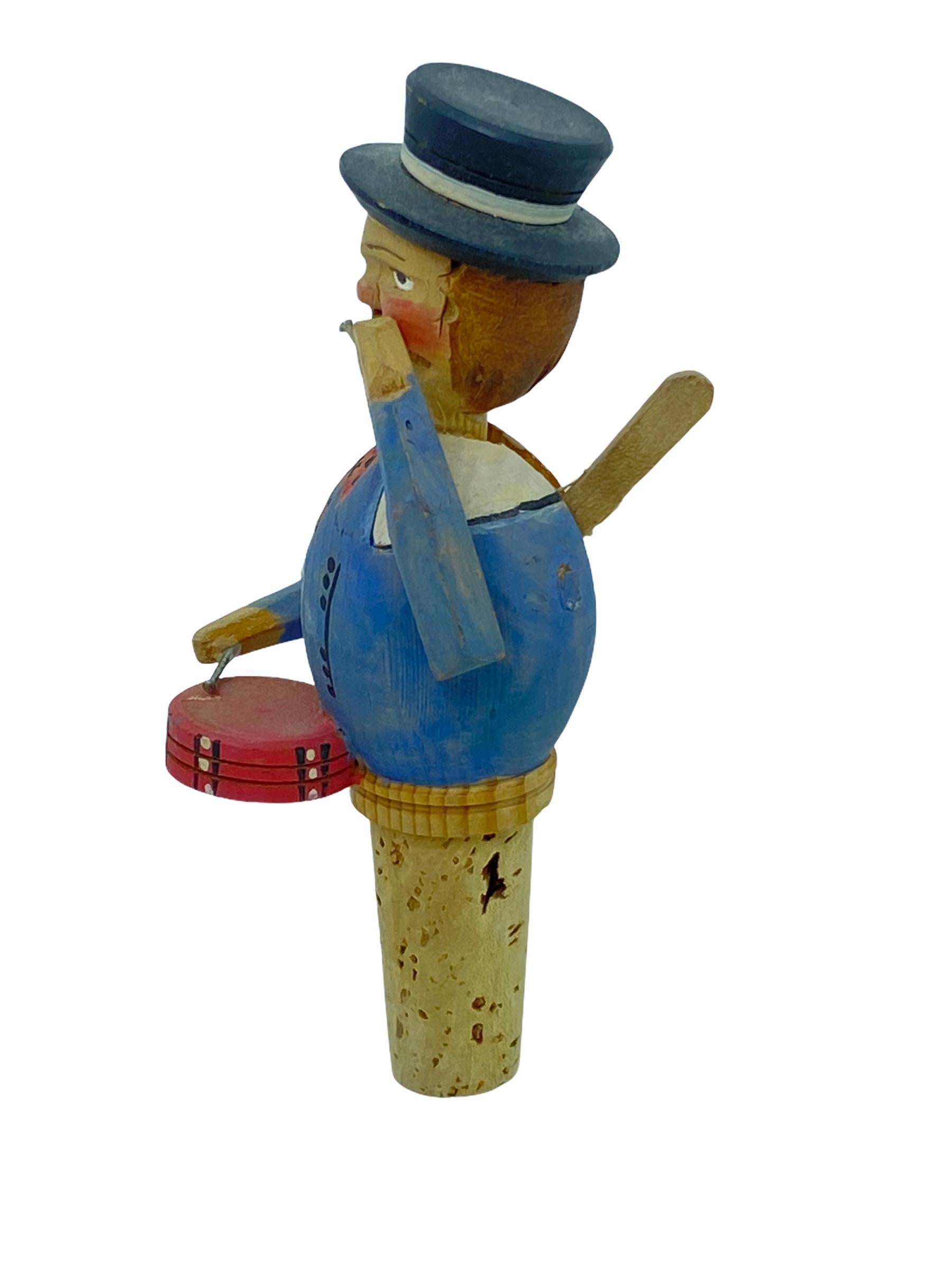 Adorable hand carved and hand painted mechanical bottle stopper. It depicts a lovely Drummer from the 1950s. There is a wooden lever on the back of the Drummer and when it is pulled down, the Man beat the drum. A nice addition to any collection or