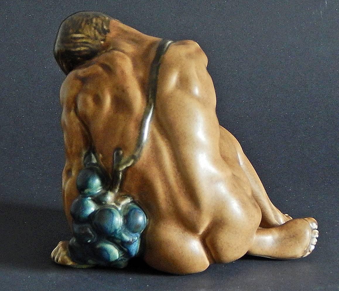 This rare and sensuous ceramic piece depicts a beautifully sculpted nude figure embracing an exaggerated grape cluster, sculpted by Kai Nielsen for Bing & Grondahl in Copenhagen. Officially noted as a 