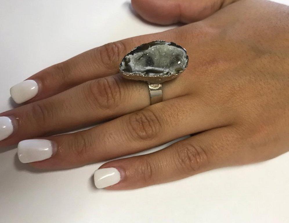 This Druzy ring is glazed with an 18K White Gold Overlay, a unique and fun addition to any look!

Material: Silver with 18K White Gold Overlay
Gemstones: 1 Druzy
Ring Size: 7. Alberto offers complimentary sizing on all rings.

Fine one-of-a-kind