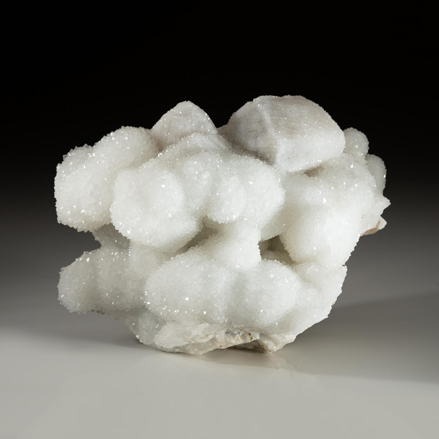 A beautiful and free-form shaped translucent druzy snow quartz clusters from Italy. This specimen has beautiful lustrous quartz crystals. A great gift and a beautiful display item in any room.

Weight: 8.5 lbs, Dimensions: 10 x 4 x 7 inches.