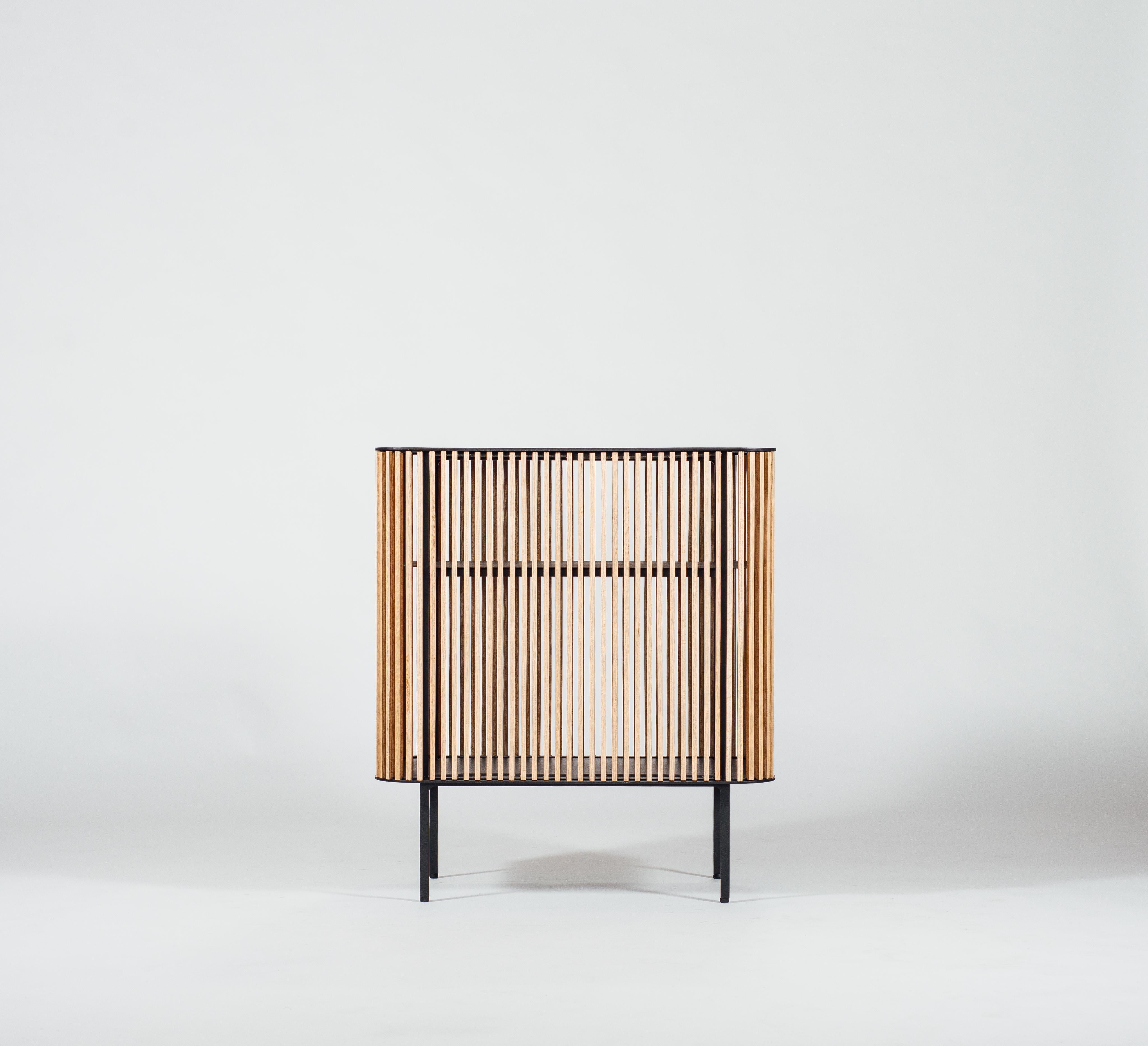 Be it in the gentleman’s corner of your apartment or centre stage in your living room, this contemporary Dry Bar in its simplicity, serves as a humble vessel for your most precious liquids. The opacity of the ribbed wood enclosure allows for one’s