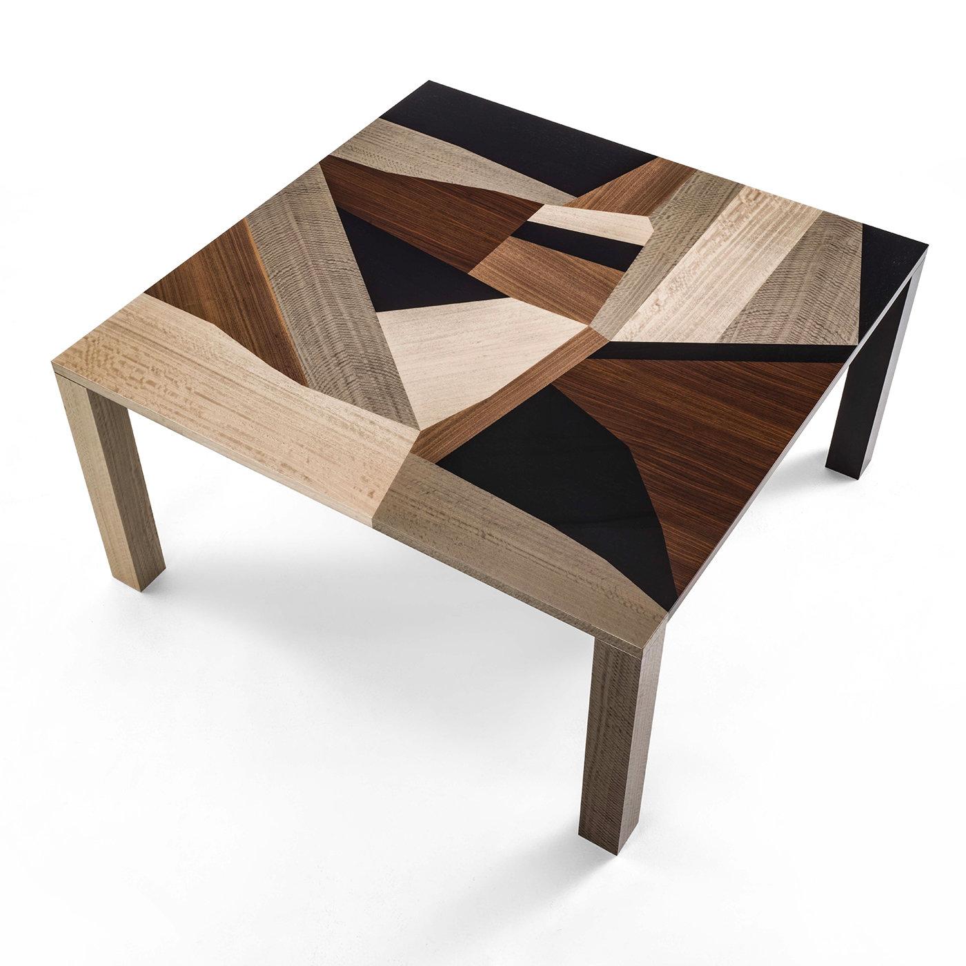 The dry table has been crafted using various types of wood inlays appearing on the top, edge and legs. An abstract geometric pattern of varying wood tones within a simple shape, in which nature and craftsmanship form the perfect union. With its