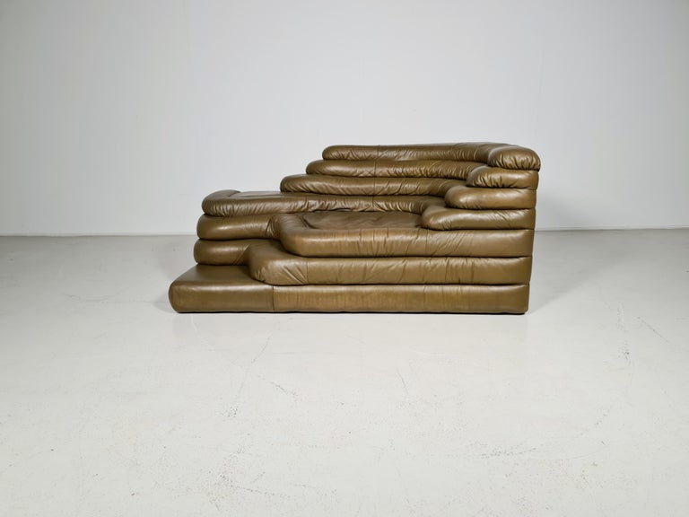 DS-1025 Terrazza Landscape sofa in the original olive green leather. By Ubald Klug for De Sede in the 1970s. The design of this sofa was inspired by waves, waterfalls, and rock formations which are clearly visible in the layering of the sofa. The