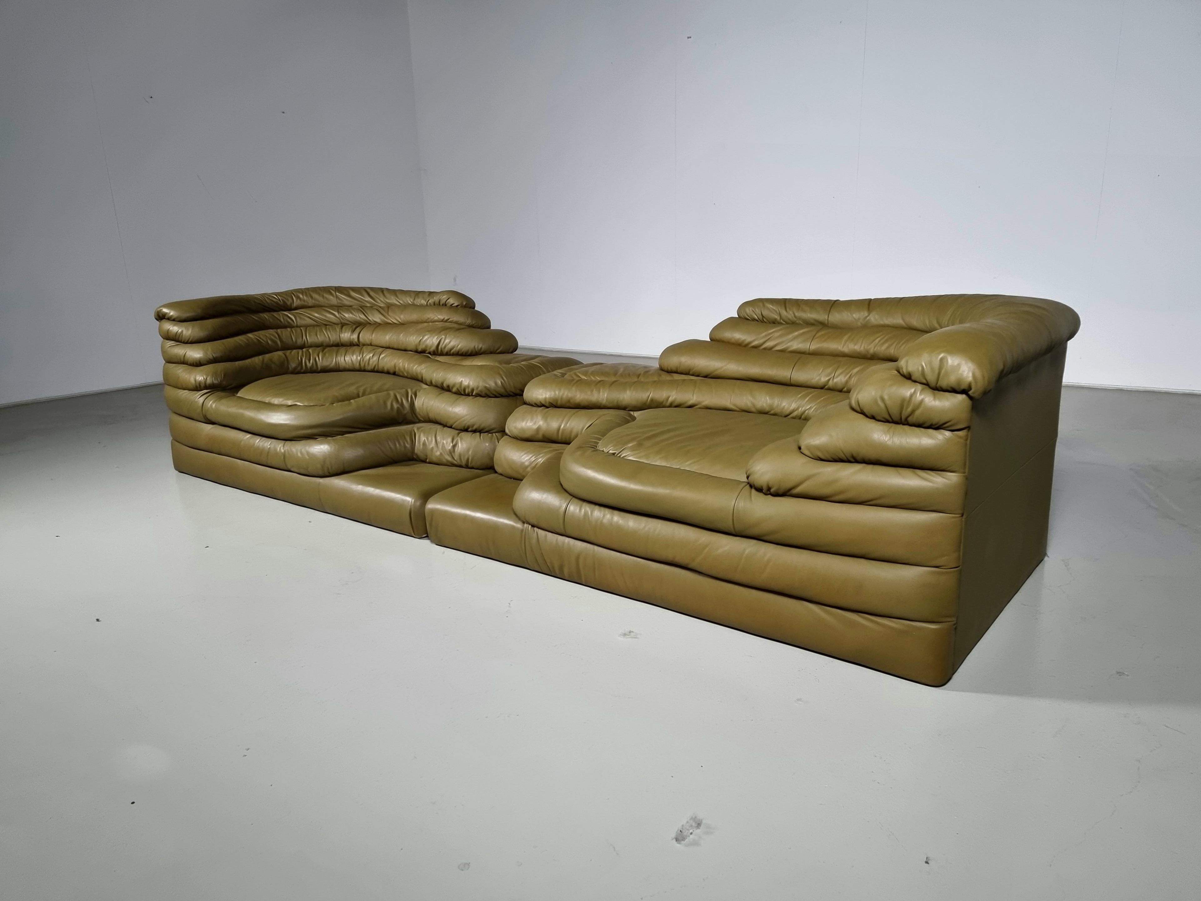 Set of two DS-1025 Terrazza Landscape sofa elements in olive green leather, by Ubald Klug for De Sede in the 1970s. The design of this sofa was inspired by waterfalls and hills which are clearly visible in the layering of the sofa. Like terraced