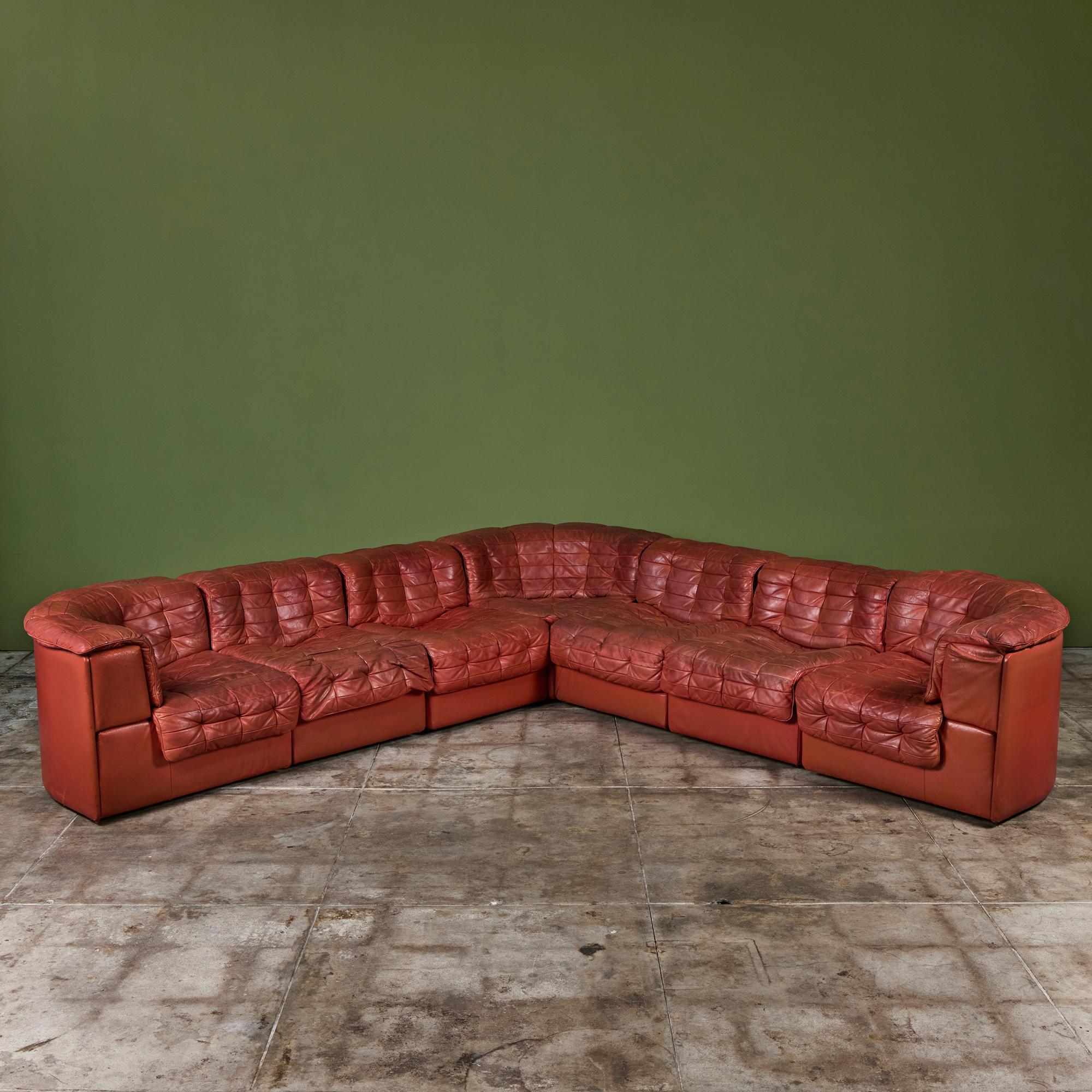 DS-11 seven piece burnt red leather sofa c.1970s, for De Sede, Switzerland. The modular system consists of three corner seats and four center seats all upholstered in the original perfectly patinated leather patchwork upholstery. It can be arranged