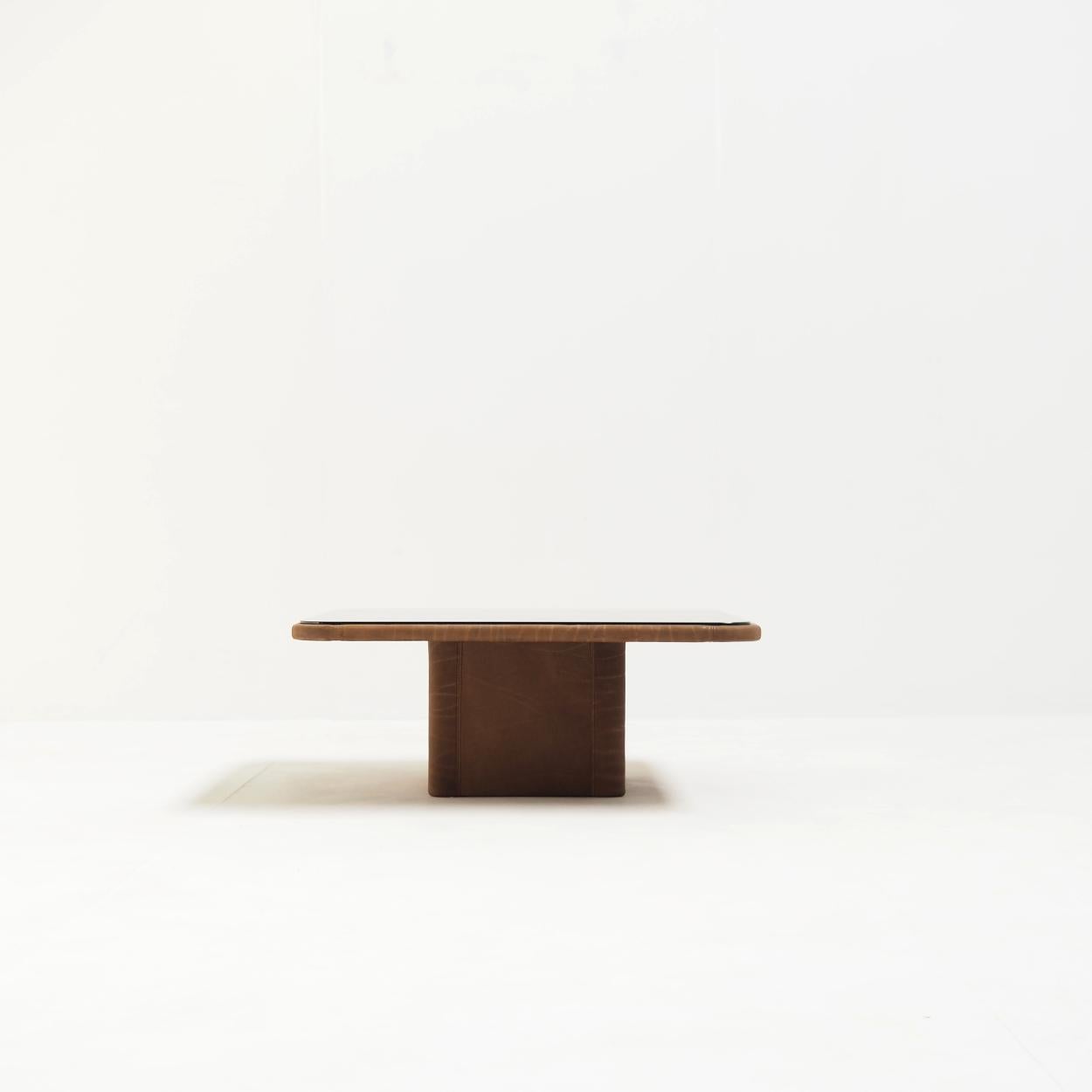 This DS-47 coffee table, designed by the in‑house De Sede Design Team, embraces a robust and minimalist aesthetic.

Its warm, organic leather is the De Sede’s signature NECK leather, which is an extra-thick, natural bullhide with distinctive