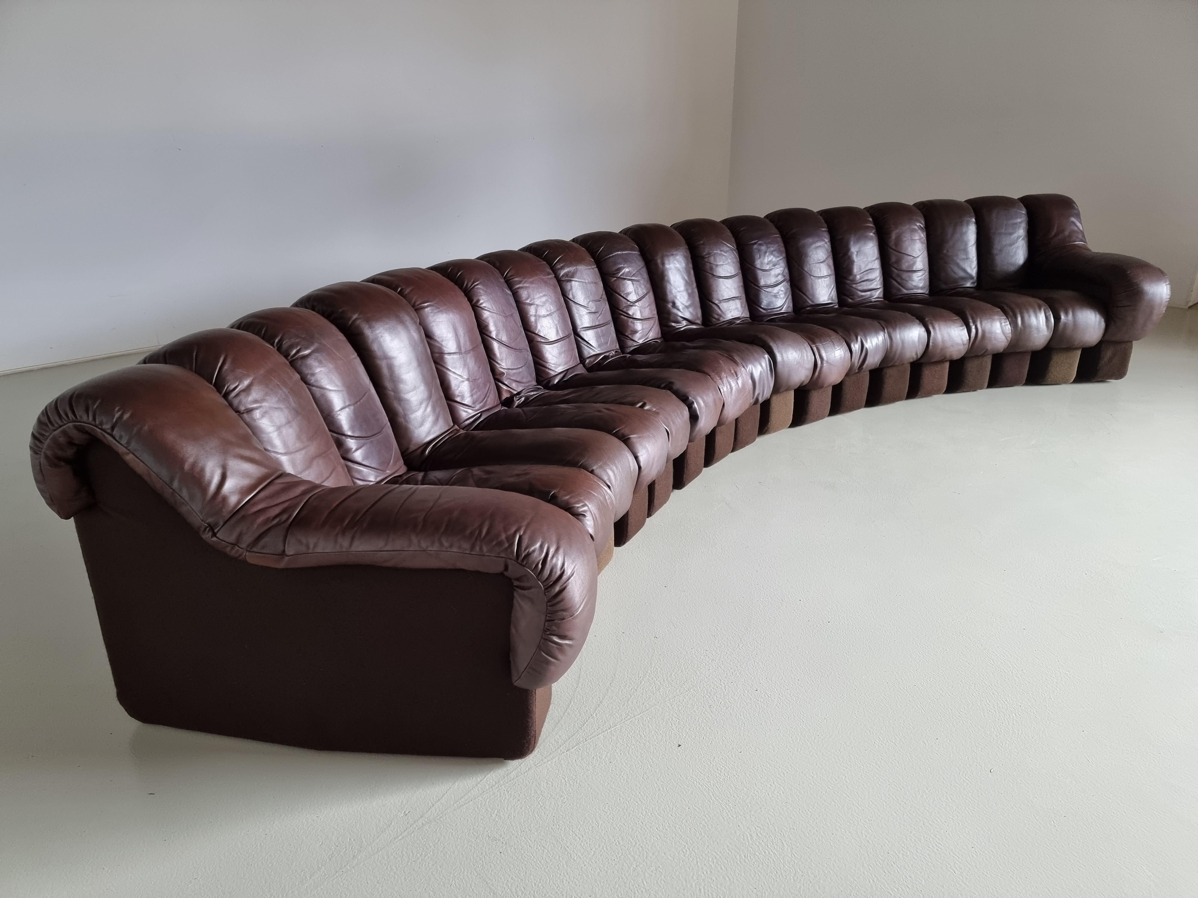 De Sede, DS600, 1970s.

This De Sede sofa in stunning patinated brown leather is designed by Ueli Bergere, Elenora Peduzzi-Riva, Heinz Ulrich, and Klaus Vogt. This sectional sofa contains 18 seating pieces with two armrests. The pieces can be