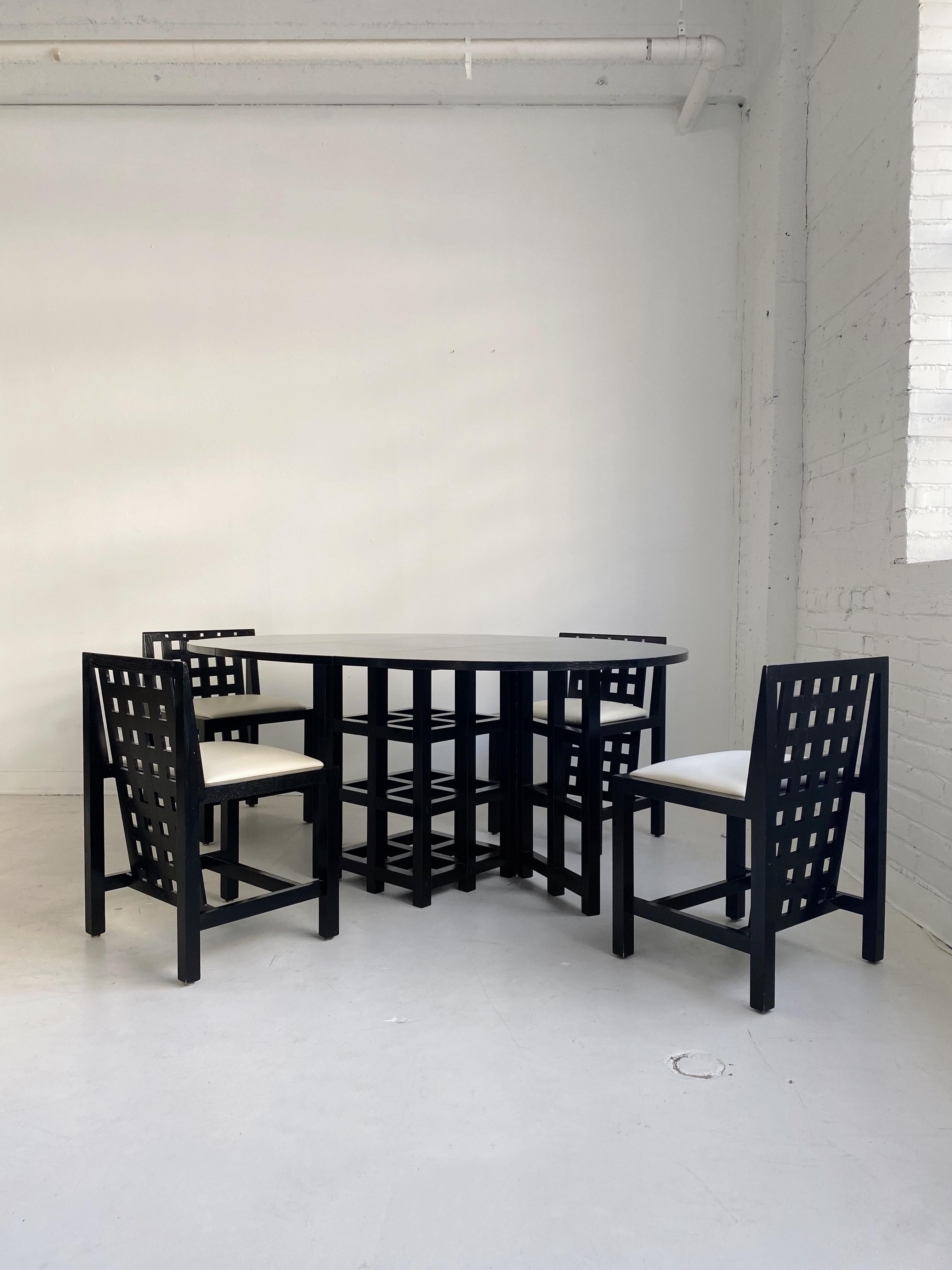 DS1 oval drop leaf dining table & 4 ds3 dining chairs by Charles Rennie Mackintosh for Cassina, 70's

Ebonized ash drop leaf table, ebonized ash chairs with mother of pearl inlays & white vinyl upholstery

Dimensions:

Table: 22.5”W closed