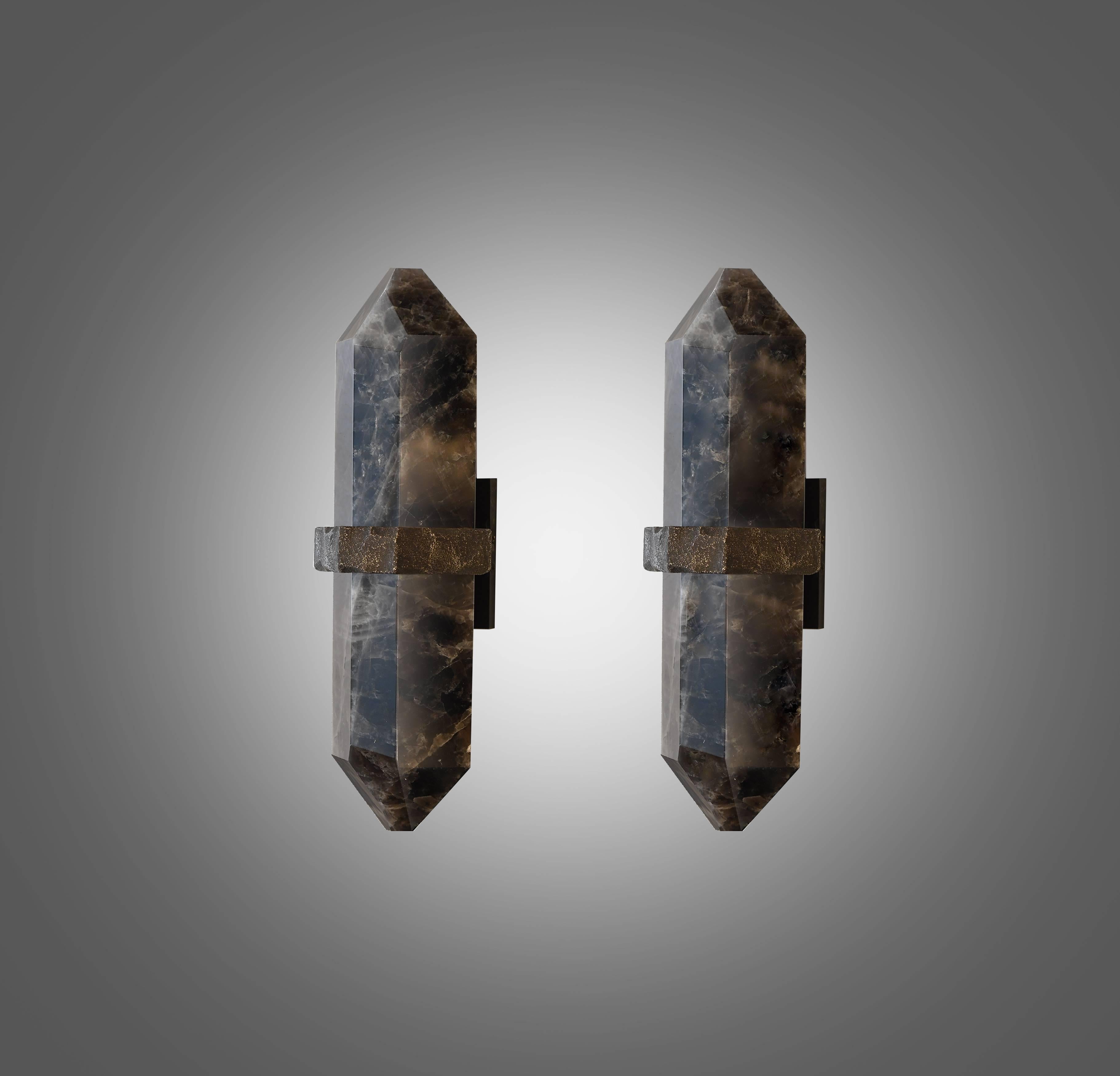 A carved diamond form smoky rock crystal quartz wall sconces, mount with rich texture of hammered brass decoration, created by Phoenix gallery NYC. 
Custom size  and  Quantity upon request.
Each sconces installed two sockets, and will including two