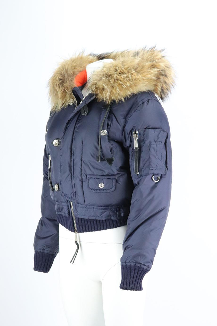 This jacket by DSquared is made from padded shell that's insulated with down, it has a raccoon fur-trimmed hood, ot's equipped with zipped pockets, including one on the sleeve and finished with appliquéd patches. Navy polyamide. Zip fastening at
