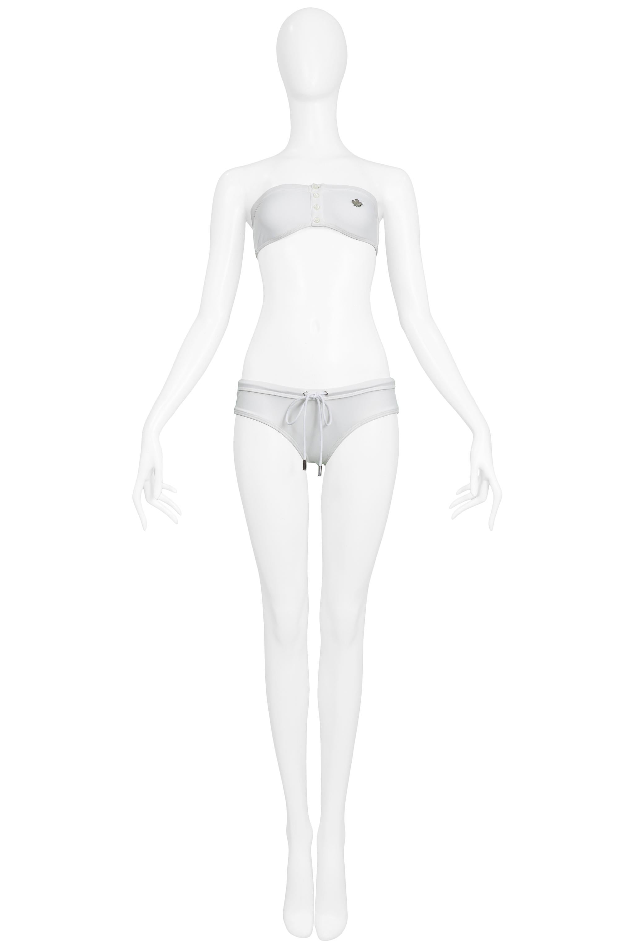 Resurrection Vintage is excited to present a vintage Dsquared white bikini swimsuit featuring a bandeau top, silver-tone leaf emblem, and bikini bottoms with drawstring. 

Dsquared
Size: M
Excellent Vintage Condition 
Authenticity Guaranteed 