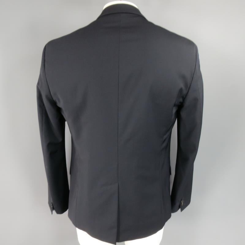DSQUARED2 Sport Coat consists of wool material in a navy color tone. Designed in a 2-button front, classic notch lapel collar with tone-on-tone stitching. Detailed with chest pocket, bottom flap pockets and 3-button cuffs. Single back vent and full