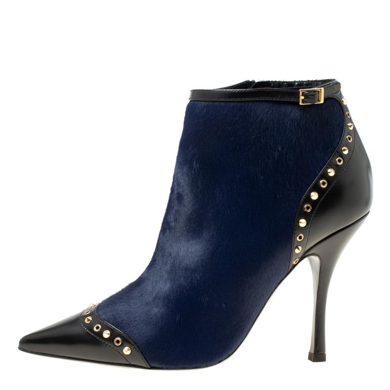 Creations from Dsquared2 are contemporary and edgy and deserve a special place in your wardrobe! These ankle boots are crafted from black leather and navy blue calf hair and feature pointed toes that are detailed with eyelets and gold-tone spikes.