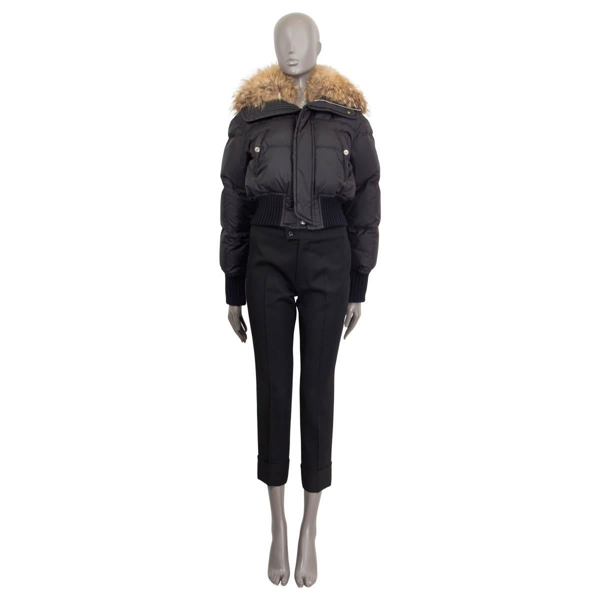 100% authentic Dsquared2 short puffer jacket in black polyamide (100%) with a fur hood (racoon 100%). Features a stitched logo patch on the back, ribbed hem and cuffs, two pockets in the front with snap buttons. Filled with the finest goose feathers