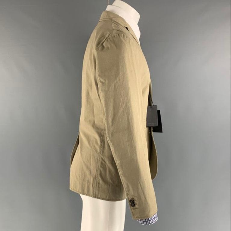DSQUARED2 sport coat comes in a khaki cotton woven material
 with a full liner featuring a notch lapel, flap pockets, single back vent, and a three button closure. Made in Italy.New with Tags. 

Marked:   50 

Measurements: 
 
Shoulder: 18 inches