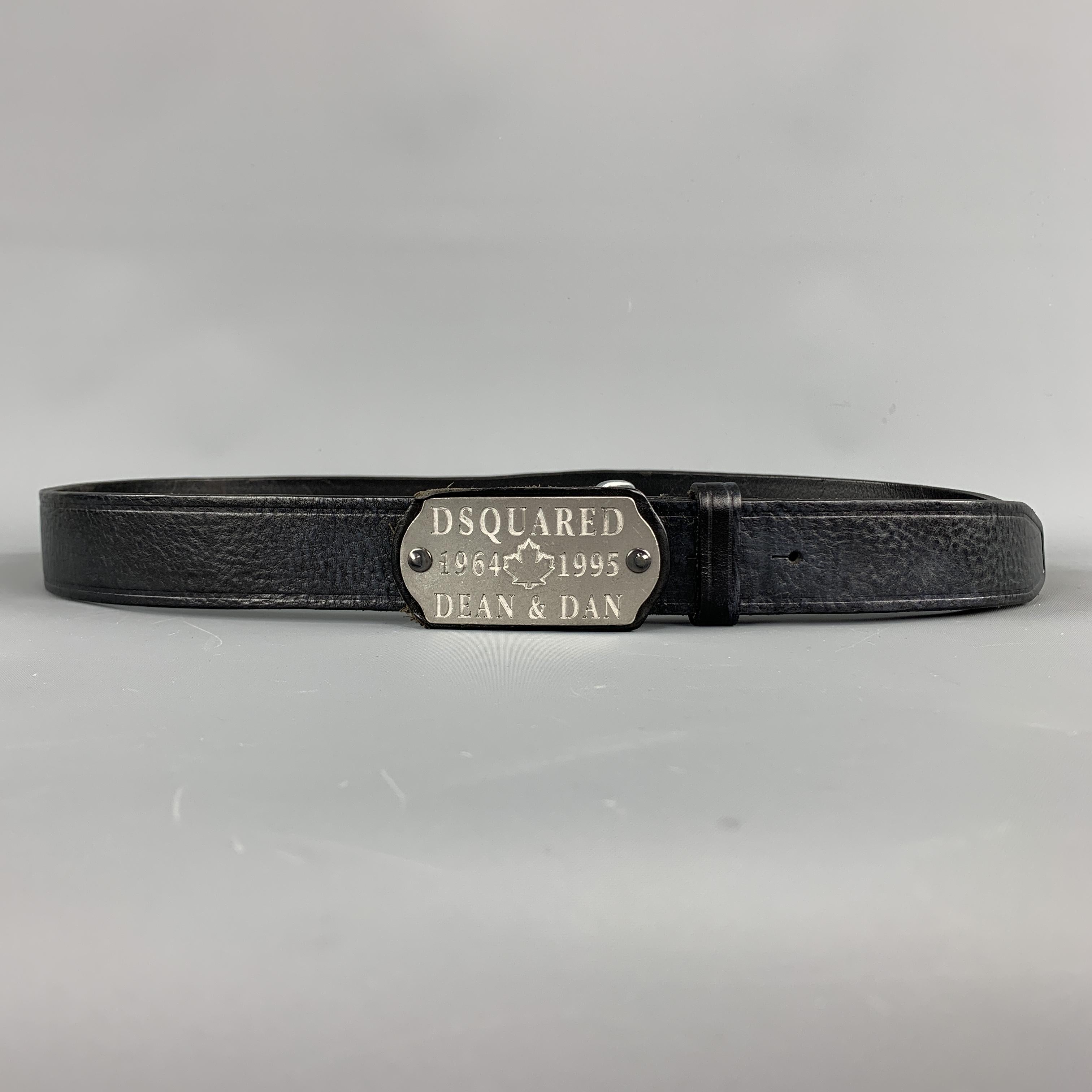 DSQUARED2 Belt comes in a black tone in a solid leather material, with a rectangular  silver tone DSQUARED2 1964 1995  Dean & Dan buckle. Wear at leather stripe. Made in Italy.
 
Very Good Pre-Owned Condition.
Marked:L
 
Length: 46.5
Width: 1.5