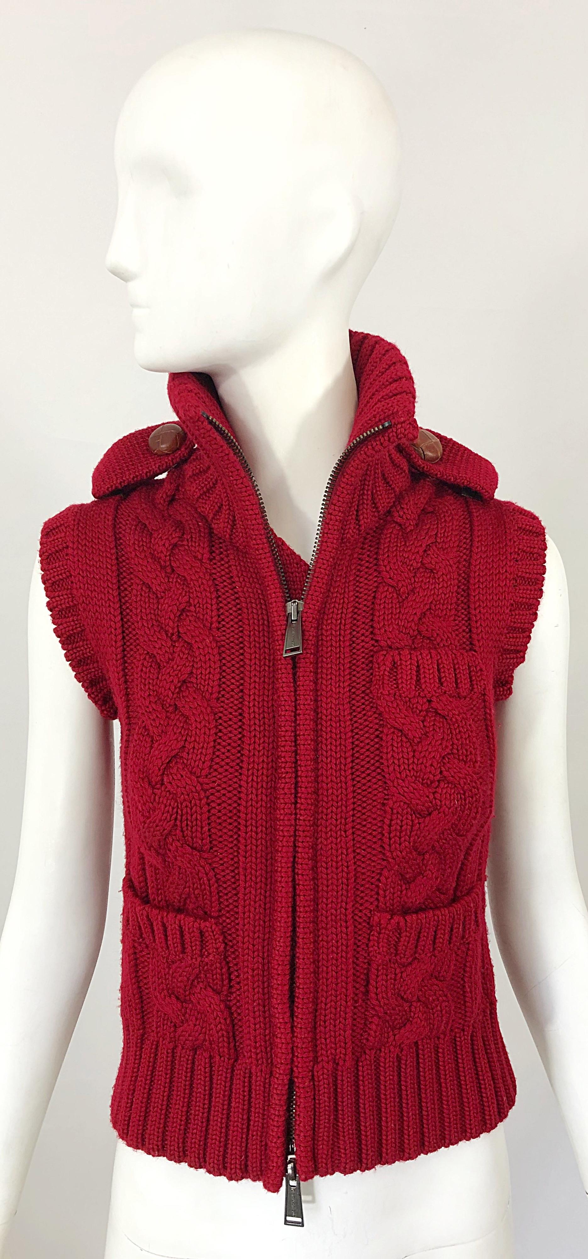 The perfect early 2000s DSQUARED2 lipstick red sleeveless wool sweater cardigan vest! Full metal zipper up the front offers the option to wear fully zipped up, partially, or opened. Pockets at each side of the waist and at left breast. Brown wood