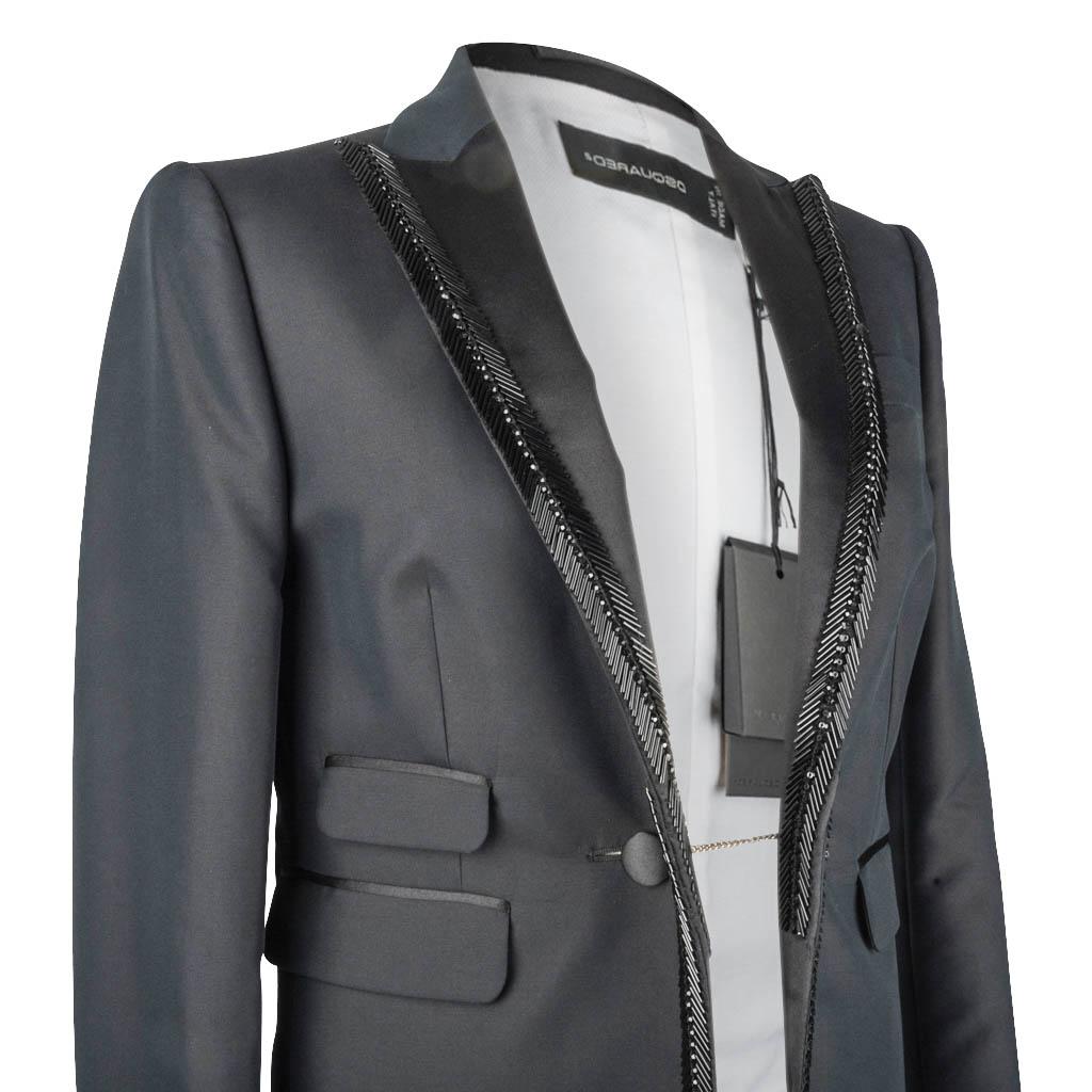 DSquared2  stunning Tuxedo style jacket.
Exquisitely shaped jet black jacket with 'French' center buttons.
Peak satin lapel edged in bugle beads that run down the front.
2 flap pockets on one side and 1 flap pocket on the other side.
1 faux breast