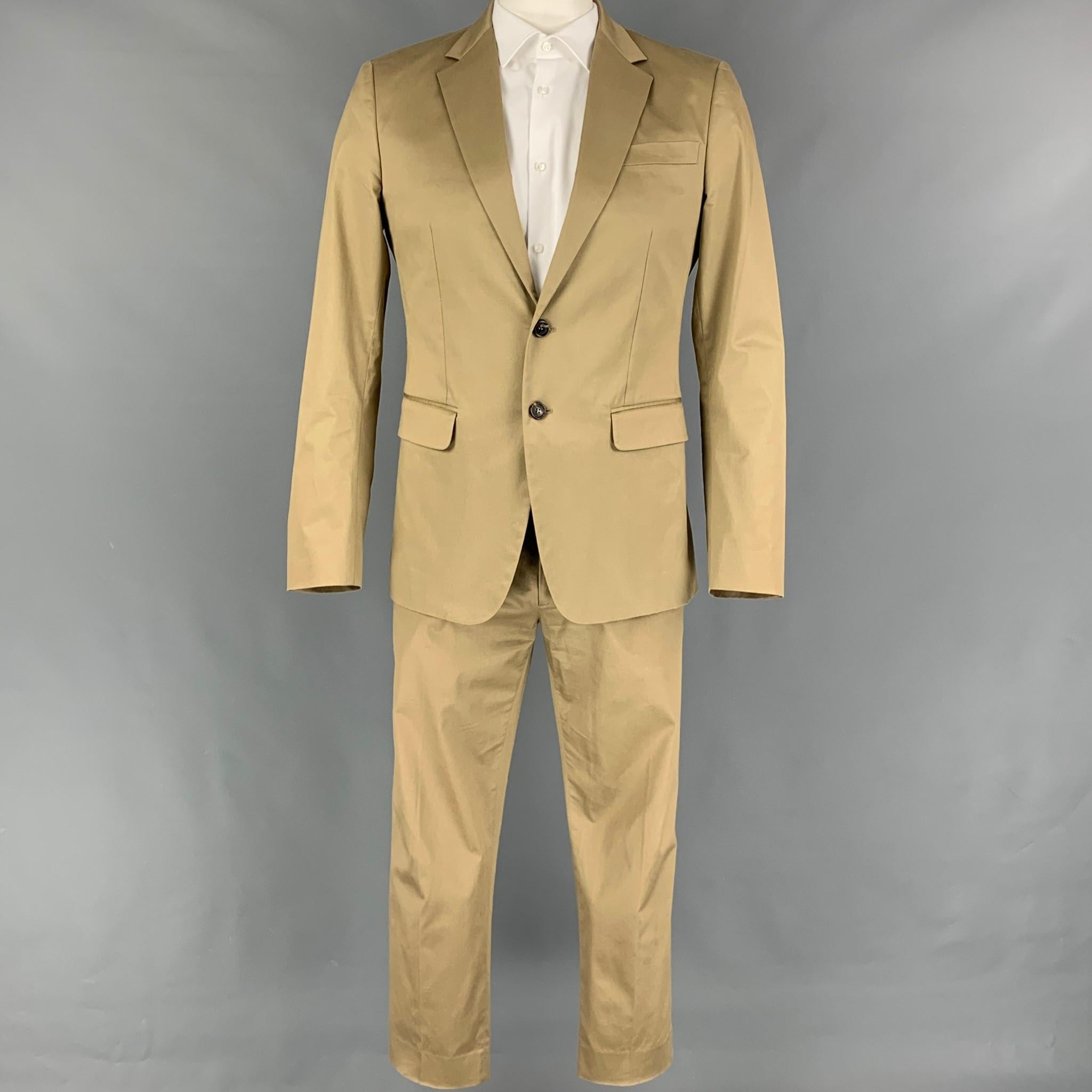 DSQUARED2 'Manchester' suit comes in a khaki cotton with a full liner and includes a single breasted, two button sport coat with a notch lapel and matching flat front trousers. Made in Italy.

Very Good Pre-Owned Condition. Light marks at pants back