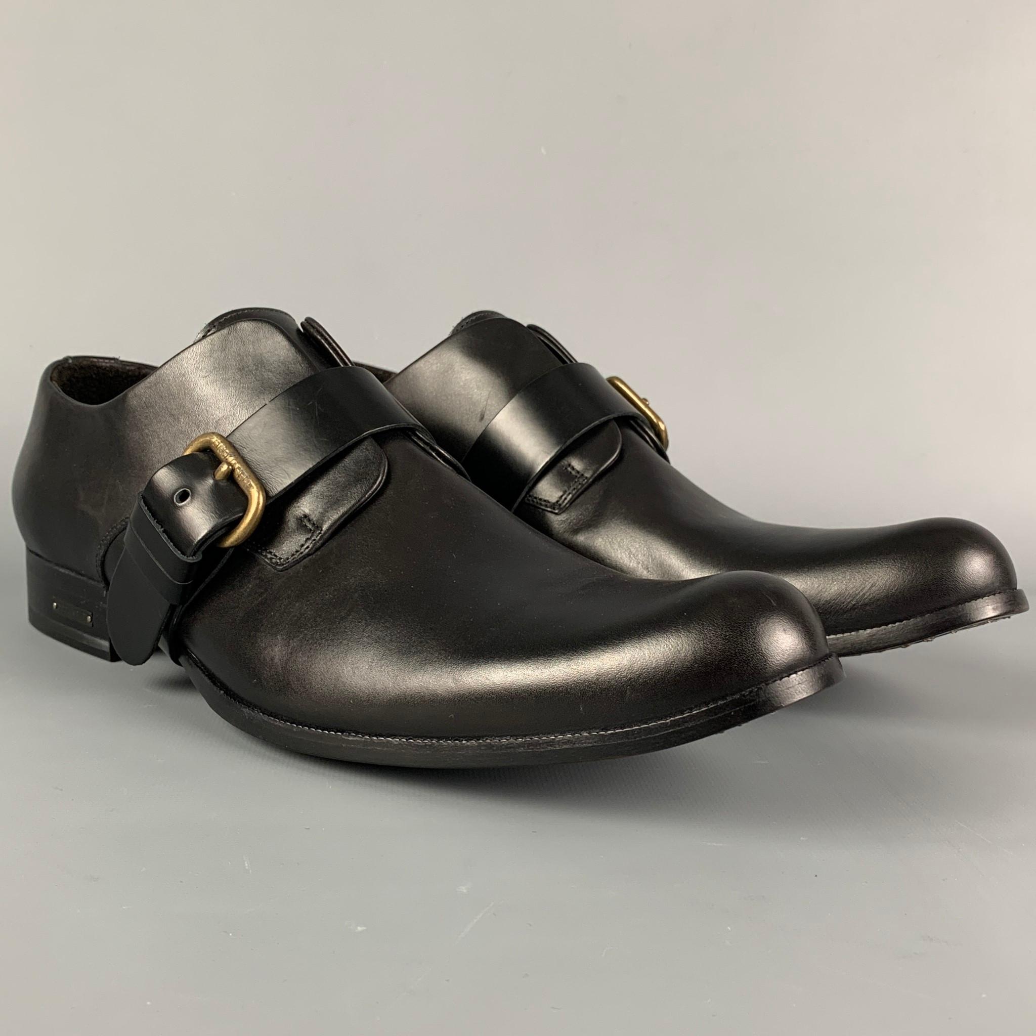 DSQUARED2 loafers comes in a black leather featuring a belted buckle strap and a leather sole. Made in Italy. Includes box. 

Excellent Pre-Owned Condition.
Marked: 44

Outsole: 12.5 in. x 4 in. 