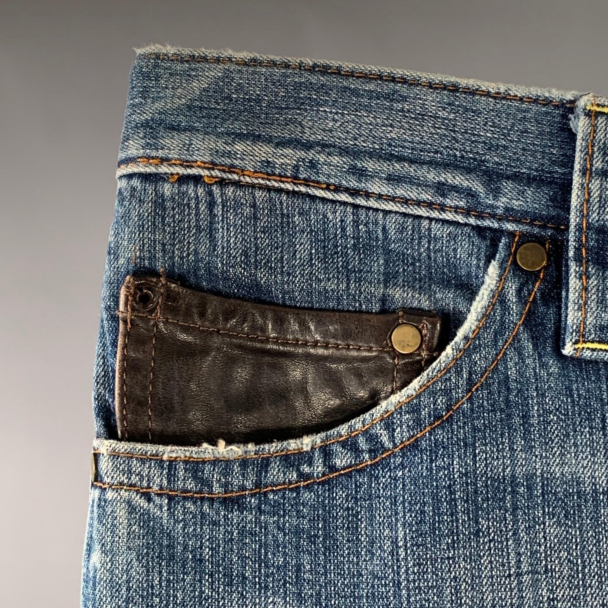 DSQUARED2 jeans
in a blue denim featuring a straight leg, black leather coin pocket detail, and large horn buttoned pockets on back. Excellent Pre-Owned Condition. 

Marked:   IT 44 

Measurements: 
  Waist: 28 inches Rise: 8 inches Inseam: 30