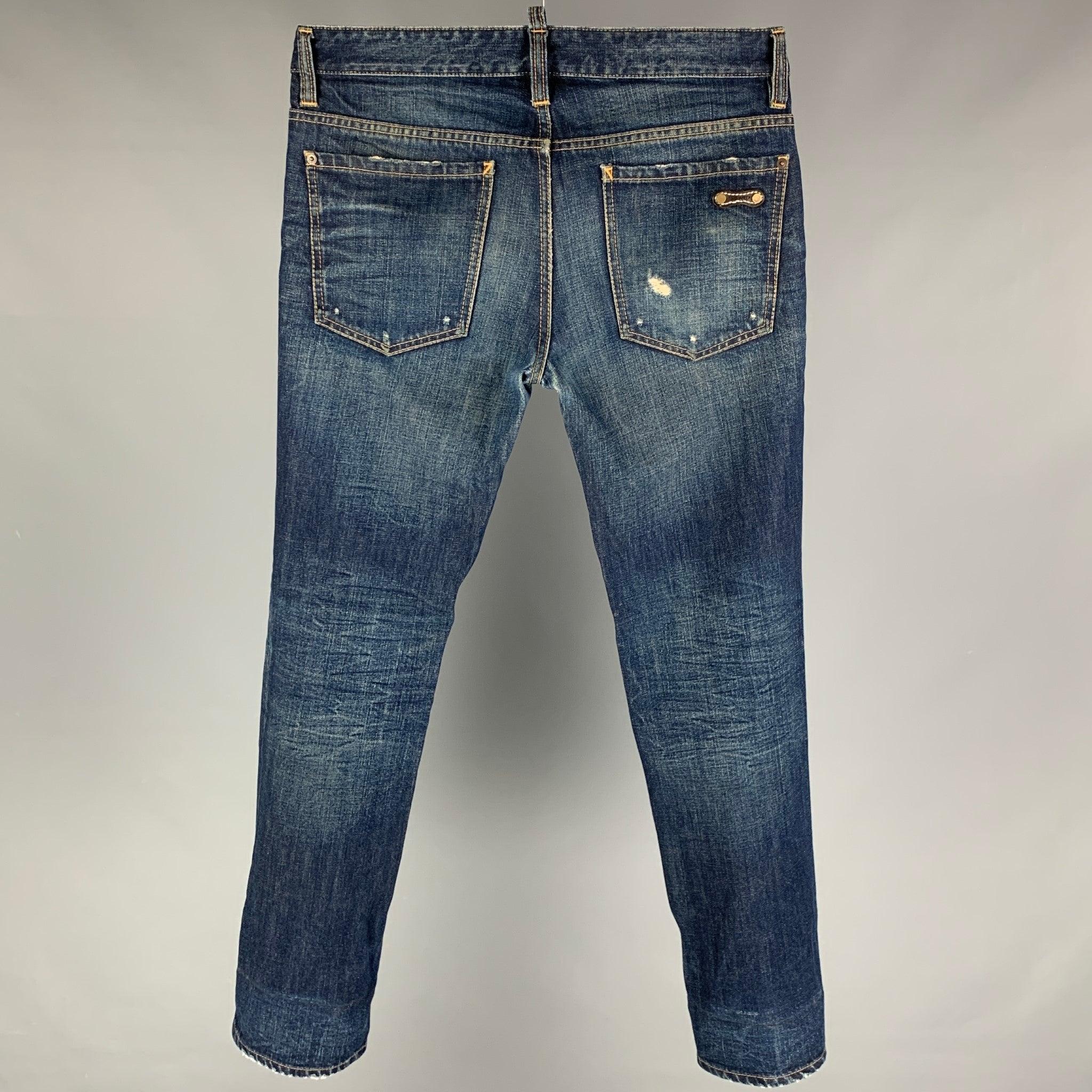DSQUARED2 jeans comes in a blue distressed material featuring a skinny fit, contrast stitching, and a button fly closure. Made in Italy. Very Good
Pre-Owned Condition. 

Marked:   46 

Measurements: 
  Waist: 33 inches  Rise: 10 inches  Inseam: 32