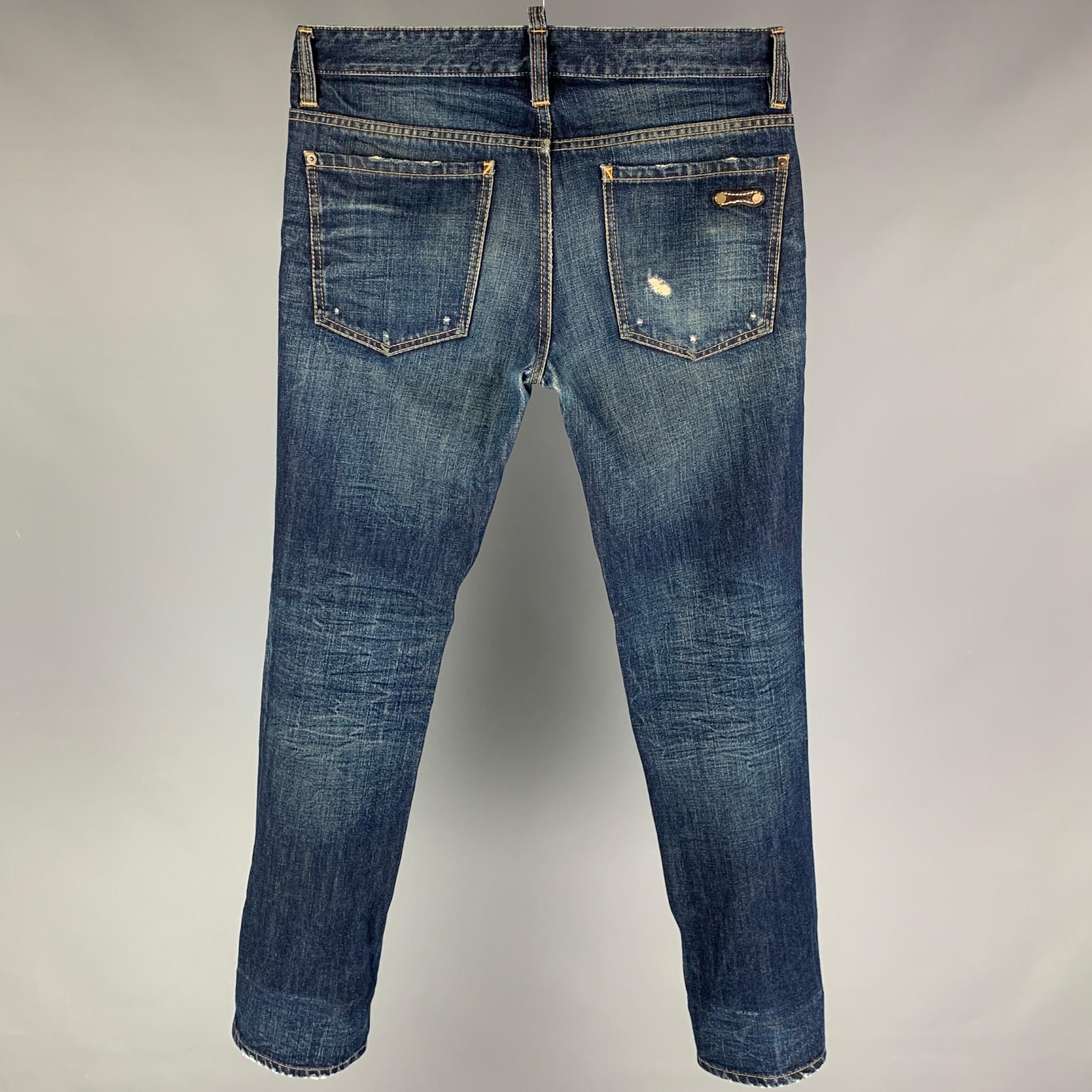 DSQUARED2 jeans comes in a blue distressed material featuring a skinny fit, contrast stitching, and a button fly closure. Made in Italy.

Very Good Pre-Owned Condition.
Marked: 46

Measurements:

Waist: 33 in.
Rise: 10 in.
Inseam: 32 in. 