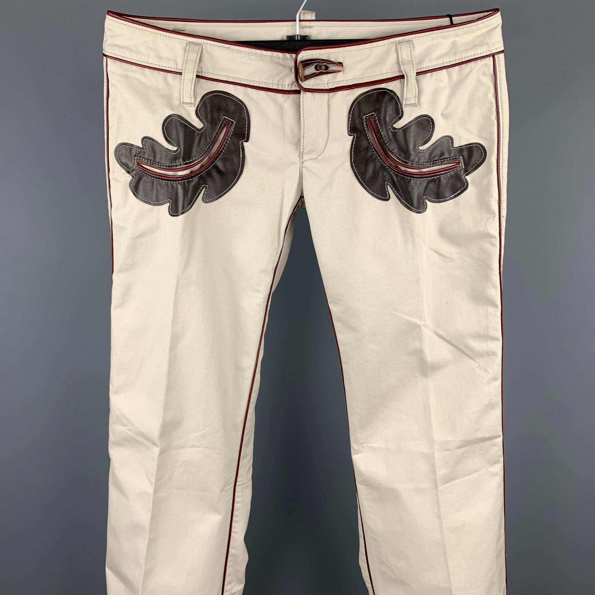 DSQUARED2 casual pants comes in a ivory cotton with front embellishments featuring a low rise style, horn button detail, and a zip fly closure. Made in Italy.

Very Good Pre-Owned Condition.
Marked: IT 46

Measurements:

Waist: 34 in. 
Rise: 5
