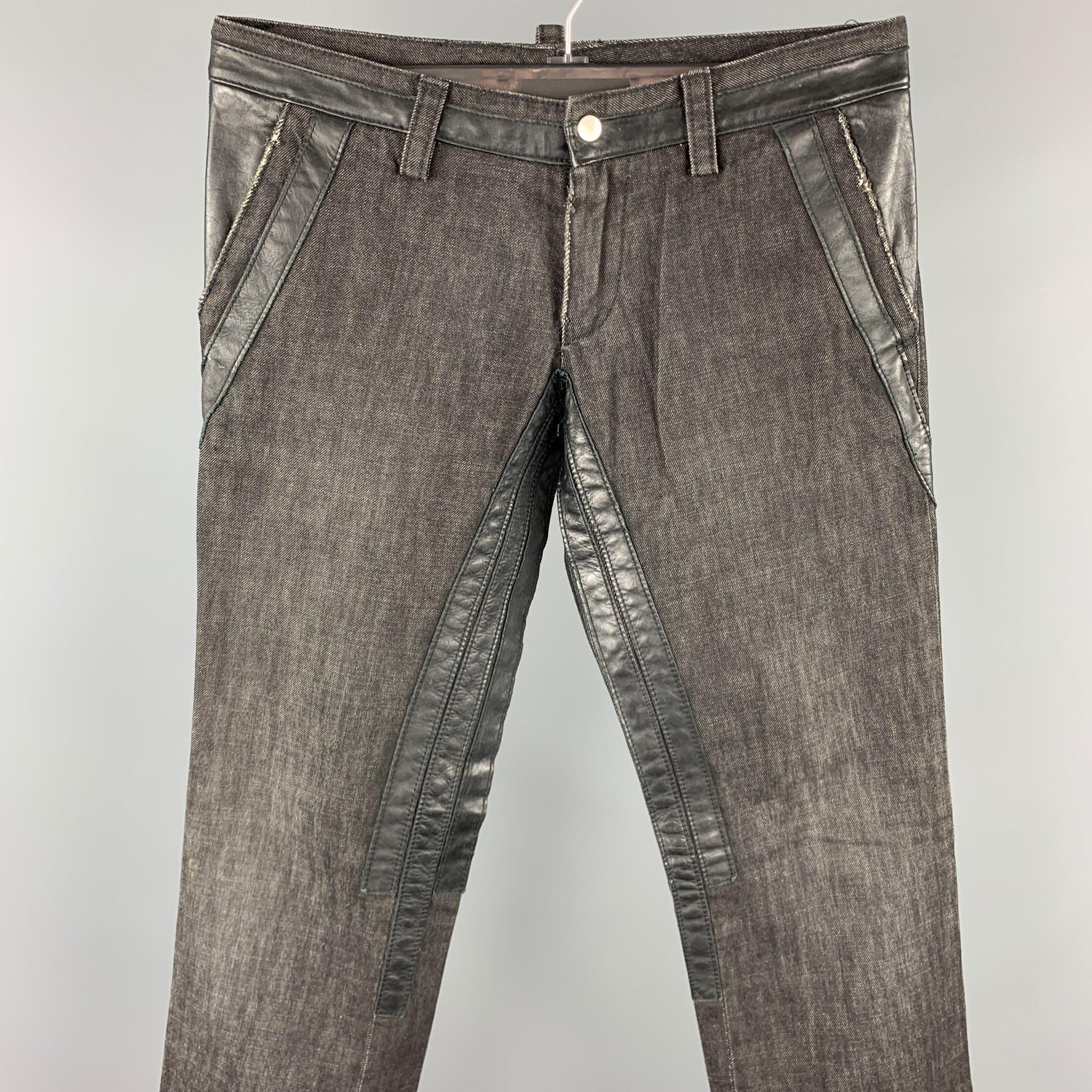 DSQUARED2 jeans comes in a black cotton with leather trim details featuring a straight leg, pocket details, and a zip fly closure. Made in Italy.

Very Good Pre-Owned Condition.
Marked: IT 48

Measurements:

Waist: 32 in.
Rise: 8 in.
Length: 34 in.