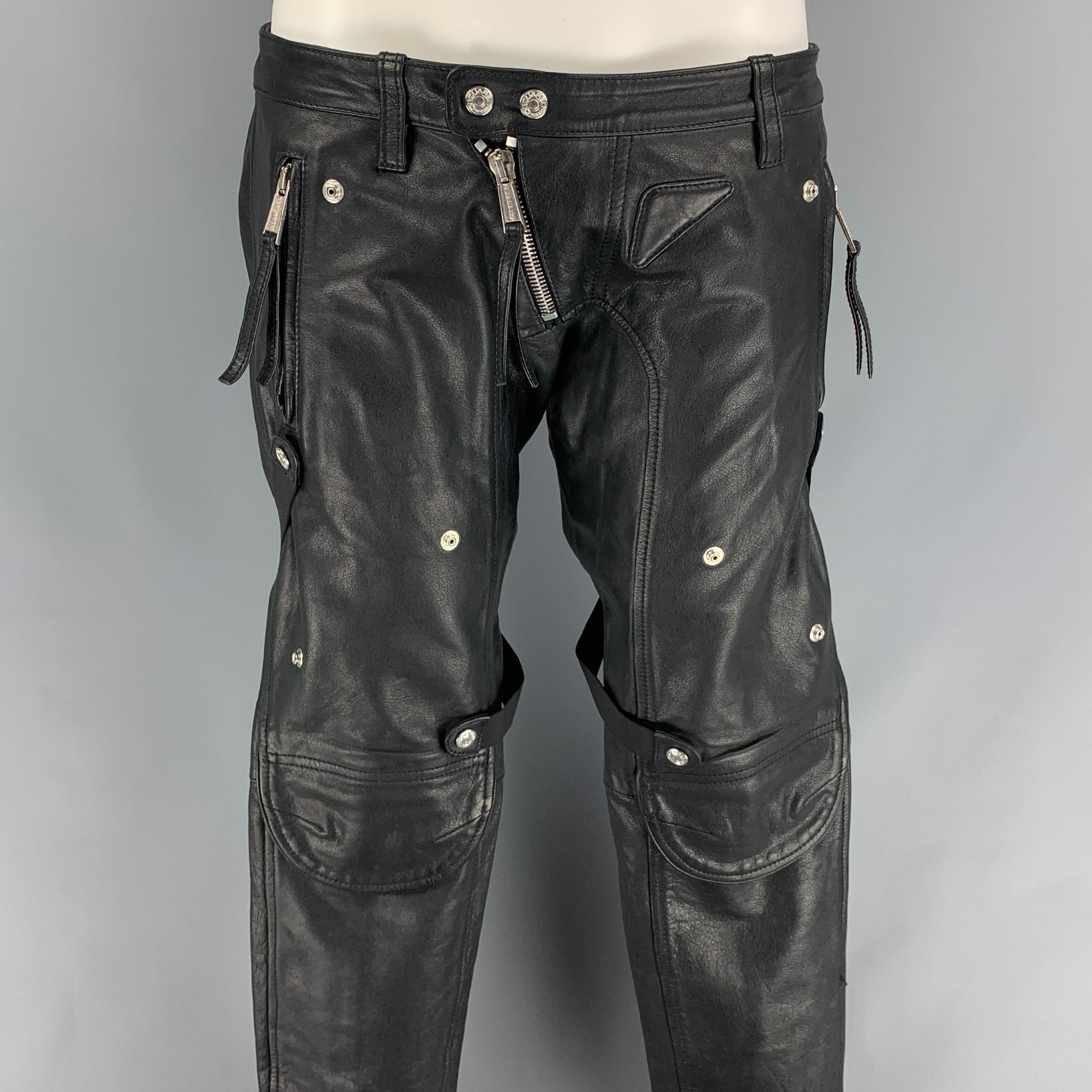 DSQUARED2 pants comes in a black leather featuring a skinny fit, low rise, zipper details, bondage straps, snap button details, zip fly, and a double snap button closure. Made in Romania. 

Very Good Pre-Owned Condition.
Marked: