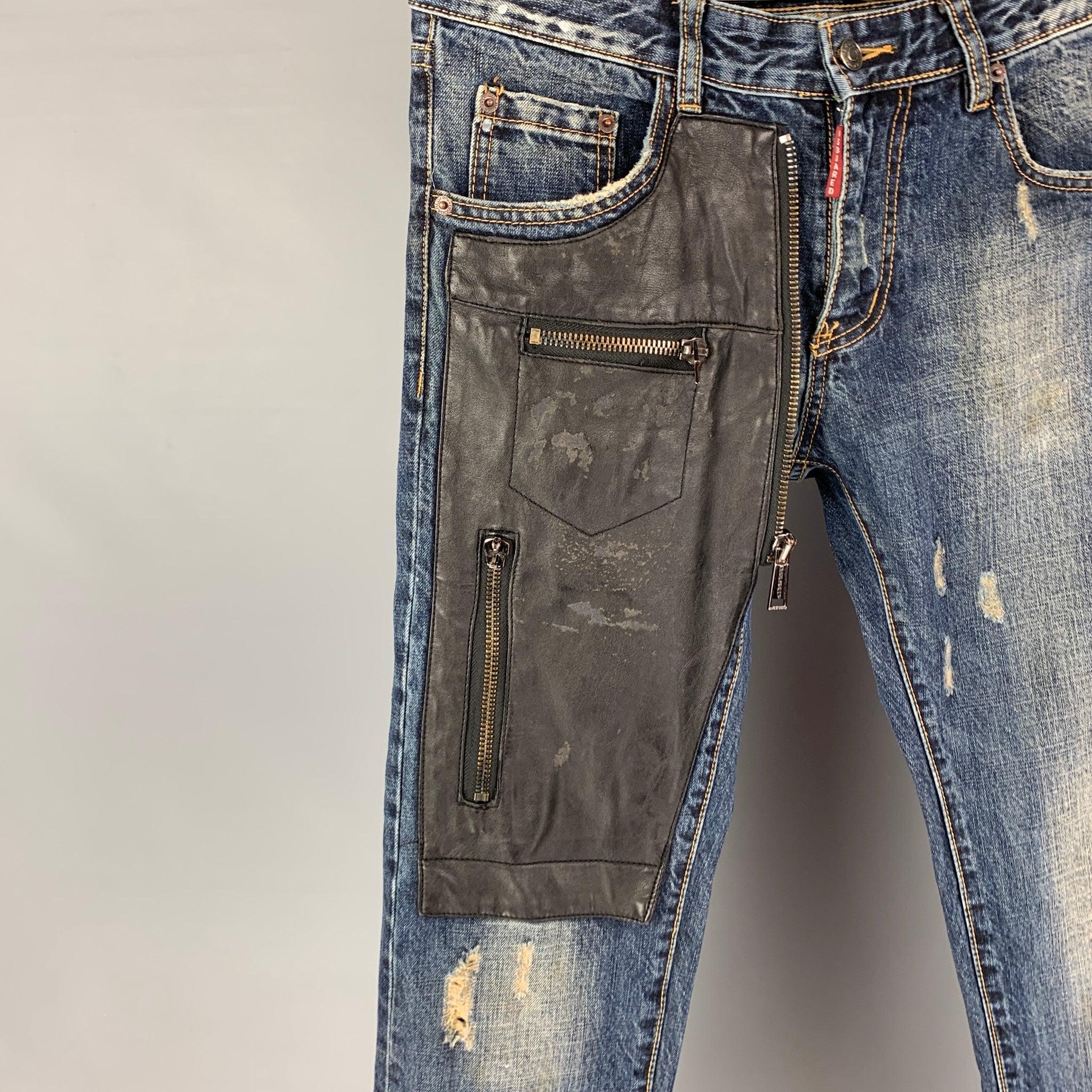 DSQUARED2 jeans comes in a blue distressed cotton featuring a skinny fit, leather patch details, and a zip fly closure. Made in Italy.
Very Good
Pre-Owned Condition. 

Marked:   32 

Measurements: 
  Waist: 34 inches Rise: 9.5 inches Inseam:
34