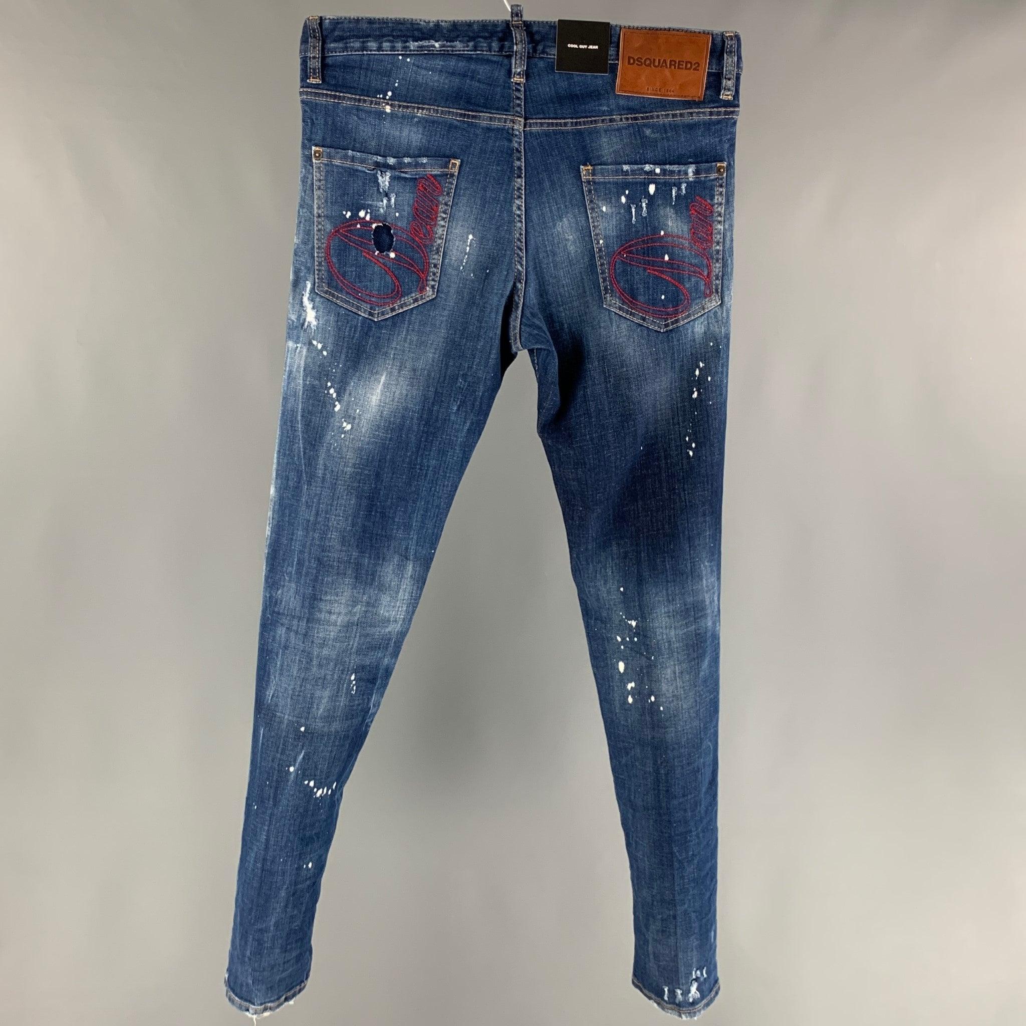 DSQUARED2 jeans comes in an indigo distressed cotton and elastane denim featuring a long crotch, paint splatter details, contrast stitching, and a button fly closure. Made in Italy.New with Tags. 

Marked:   48 

Measurements: 
  Waist: 34 inches