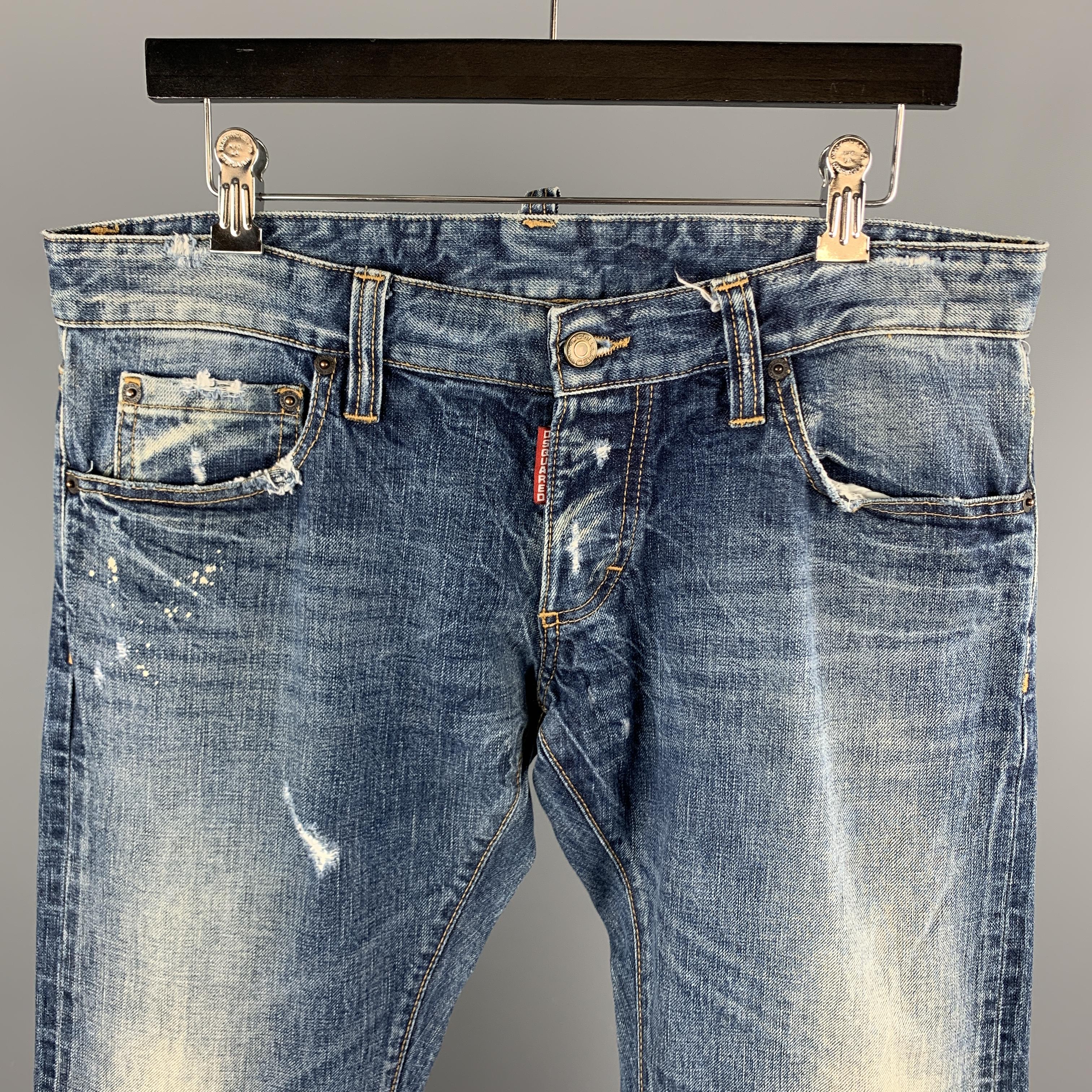 DSQUARED2 jeans comes in a blue washed denim featuring distressed details, contrast stitching, and a button fly closure. Made in Italy. 

Excellent Pre-Owned Condition.
Marked: IT 48

Measurements:

Waist: 32 in. 
Rise: 7 in.
Inseam: 35 in. 