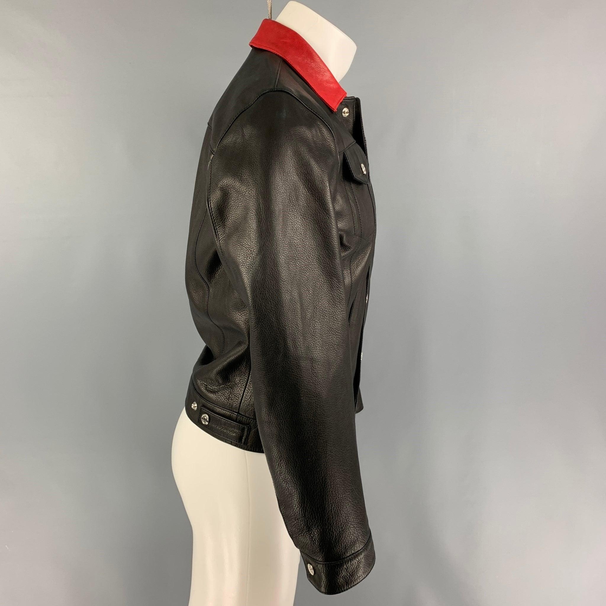 DSQUARED2 jacket comes in a black leather with a full liner featuring a trucker style, red collar, front pockets, and a snap button closure. Made in Italy.
Good
Pre-Owned Condition. Moderate discoloration at back. 

Marked:   46 

Measurements: 
