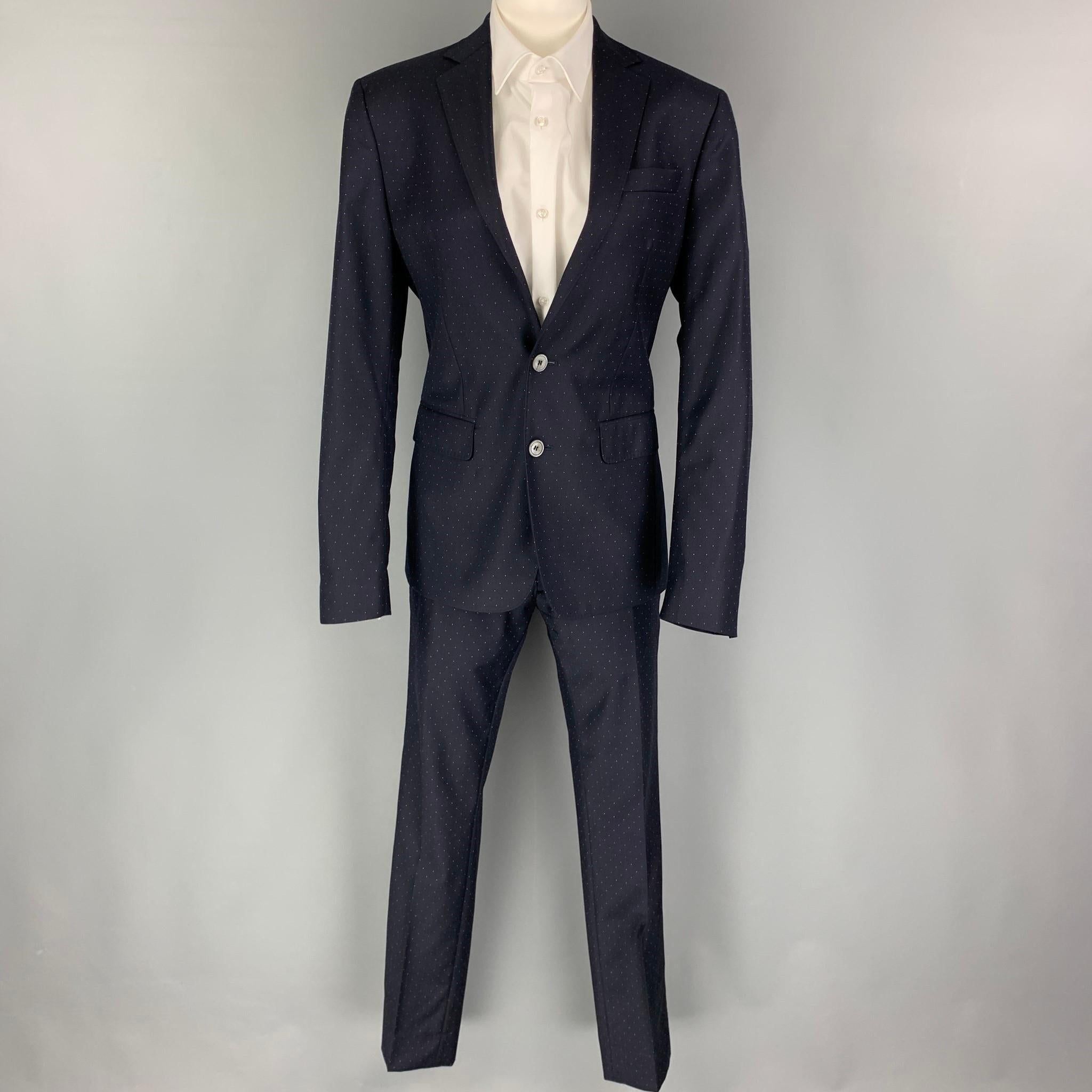 DSQUARED2 suit comes in a navy & white dot print wool with a full liner and includes a single breasted, double button sport coat with a notch lapel and matching flat front trousers. Made in Italy.

Excellent Pre-Owned Condition.
Marked: