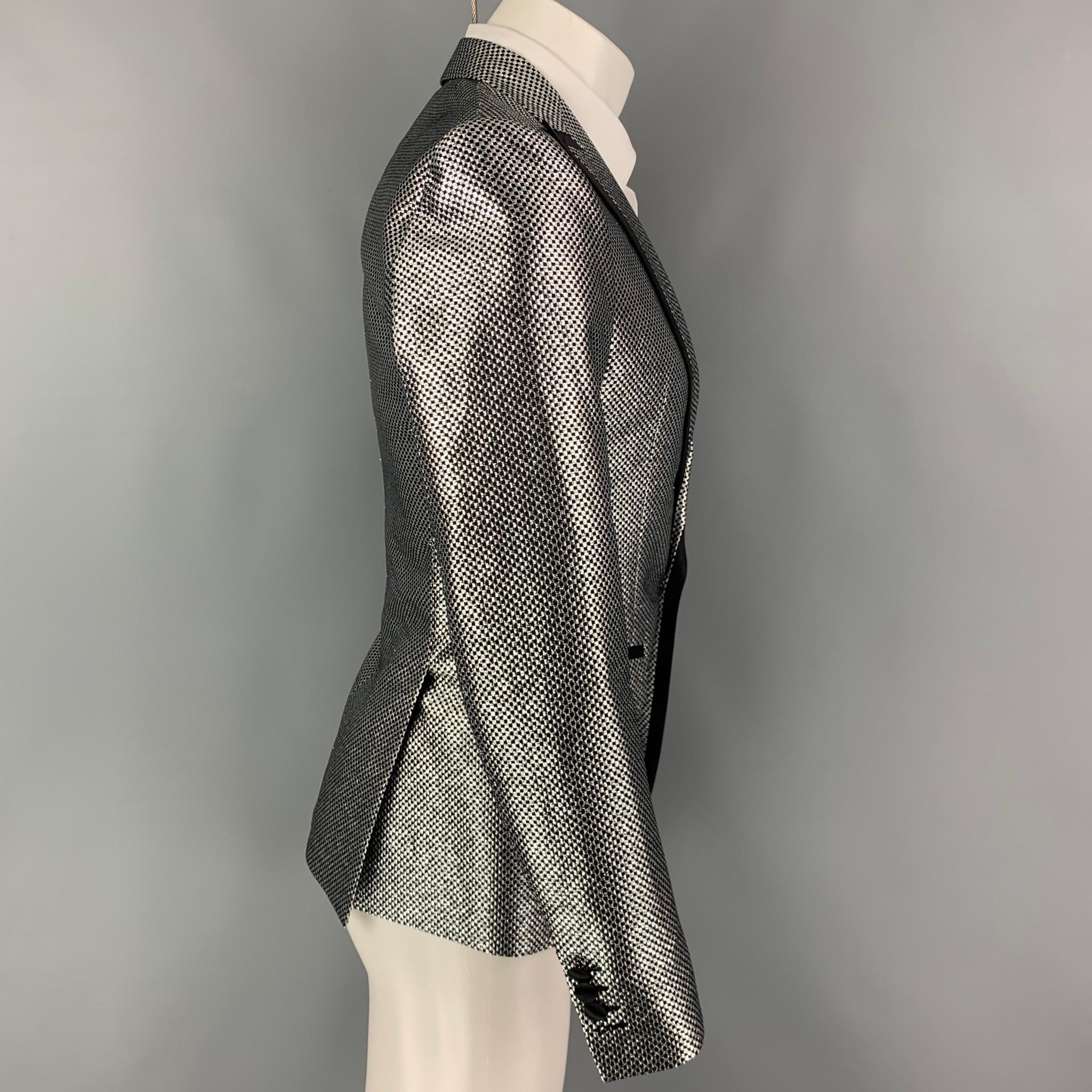 DSQUARED2 sport coat comes in a silver & black checkered polyester / silk with a full liner featuring a peak lapel, flap pockets, double back vent, and a single button closure. Made in Italy. 

Excellent Pre-Owned Condition.
Marked: